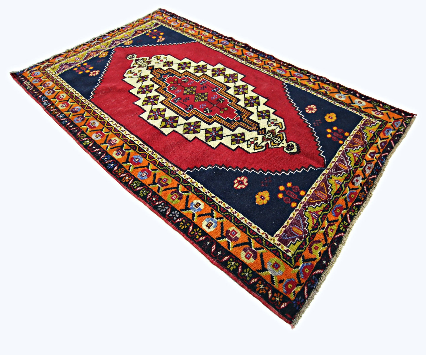 A vintage handmade Turkish Taspinar rug featuring a red central medallion on a dark blue field.