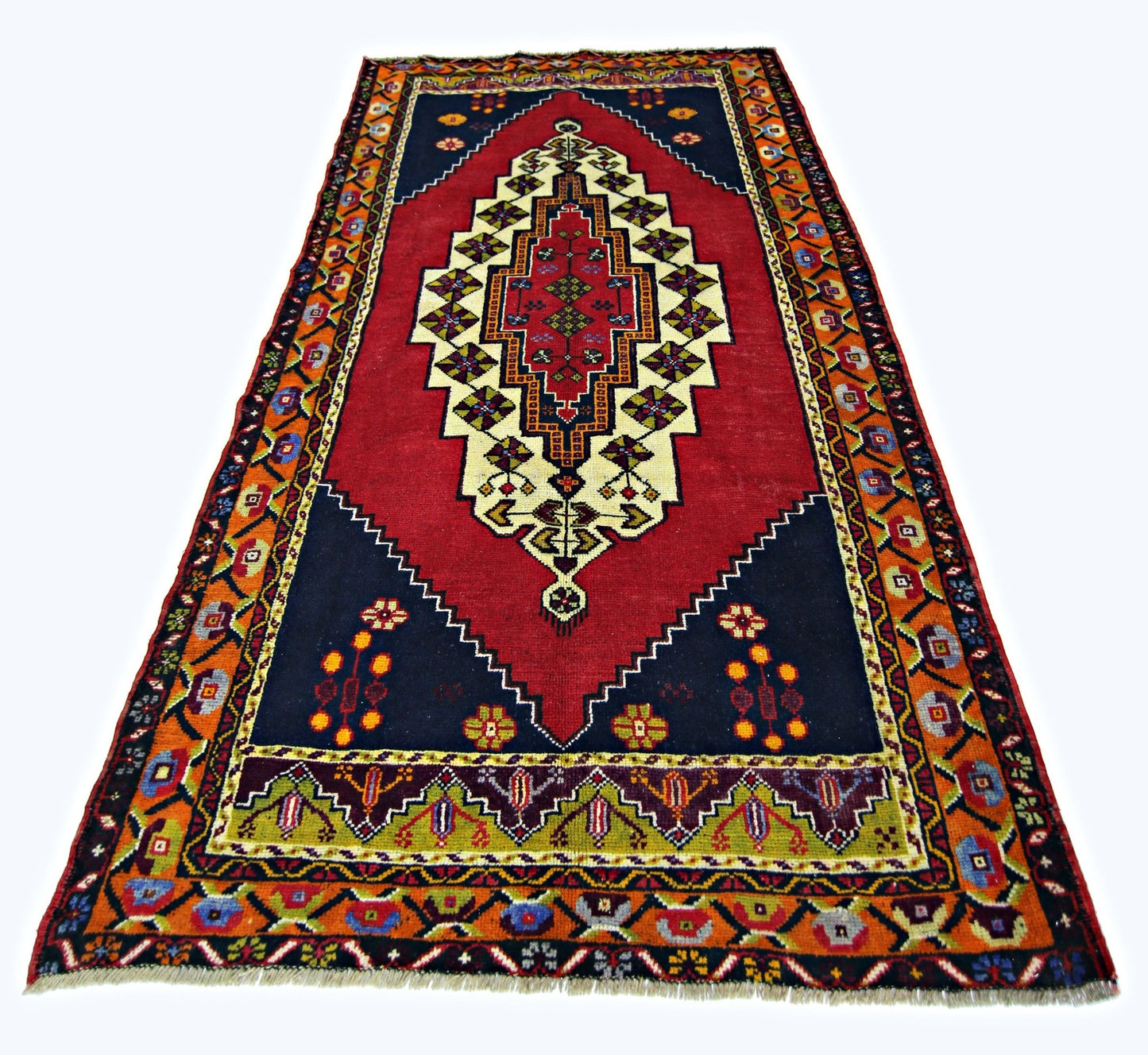 A vintage handmade Turkish Taspinar rug featuring a central geometric medallion on a red field.