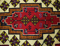 A vintage Turkish Taspinar rug featuring a red central medallion with geometric floral patterns.