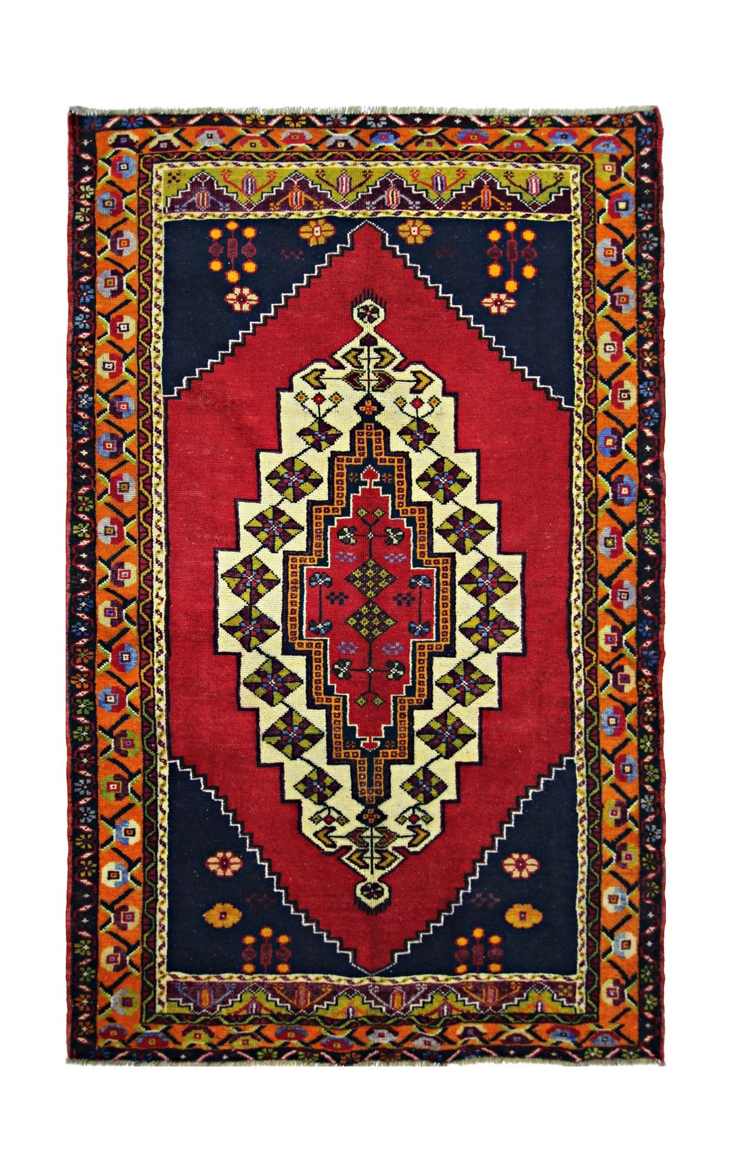 A vintage handmade Turkish Taspinar rug featuring a geometric medallion on a red and navy field.