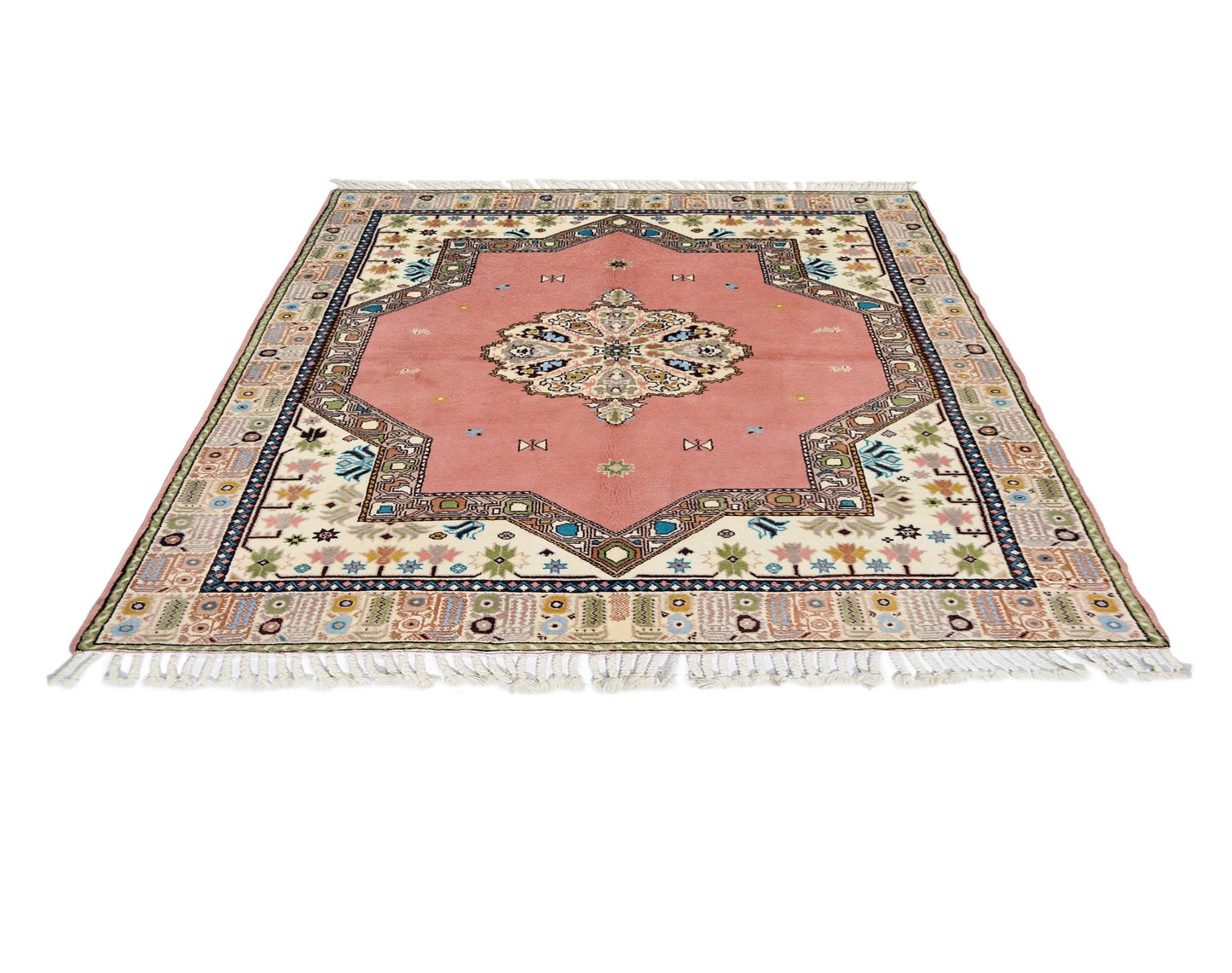 A vintage Turkish Yoruk rug featuring a pink central medallion and intricate geometric borders.
