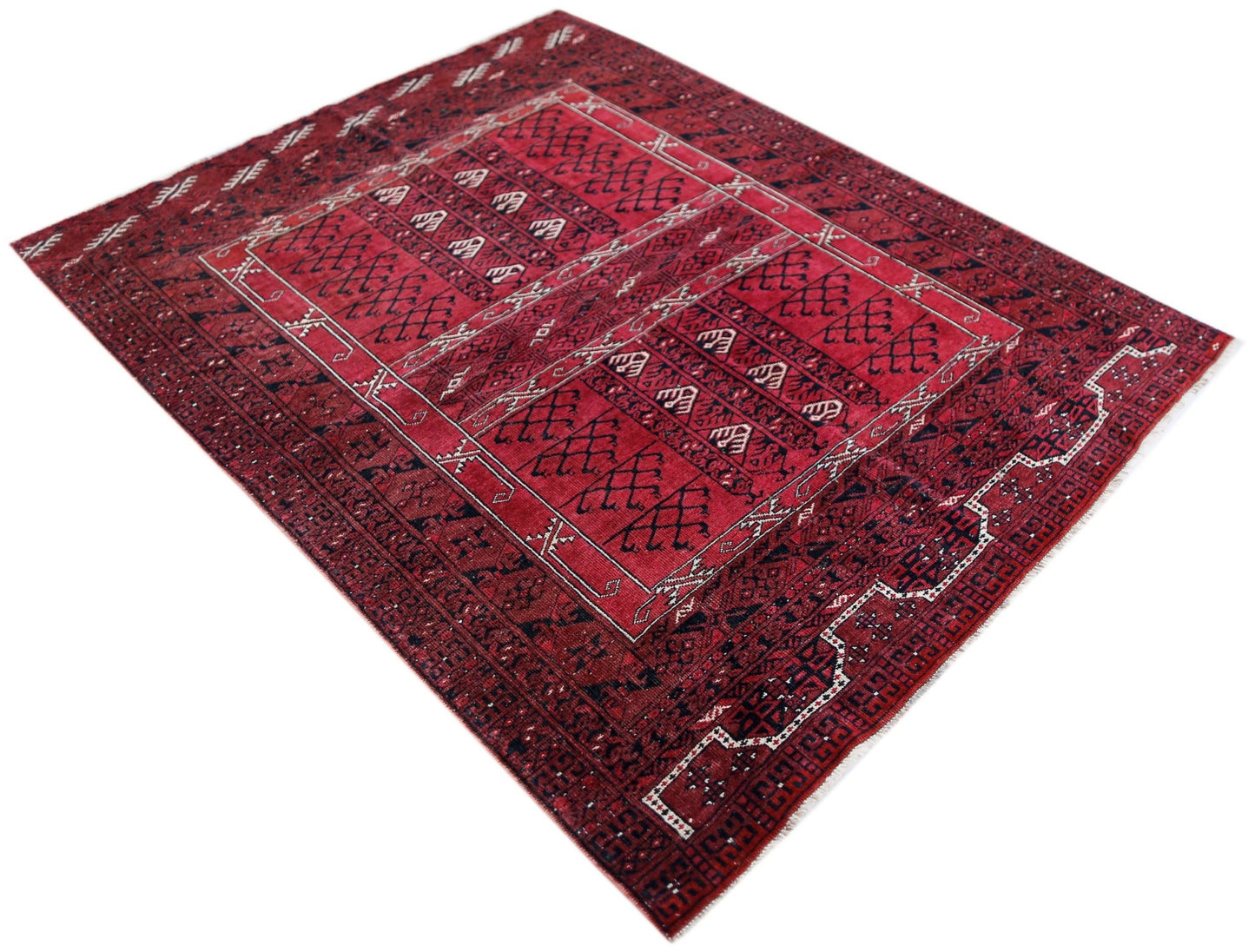 A handwoven vintage Afghan Turkmen Engsi rug featuring a geometric red and dark blue pattern.