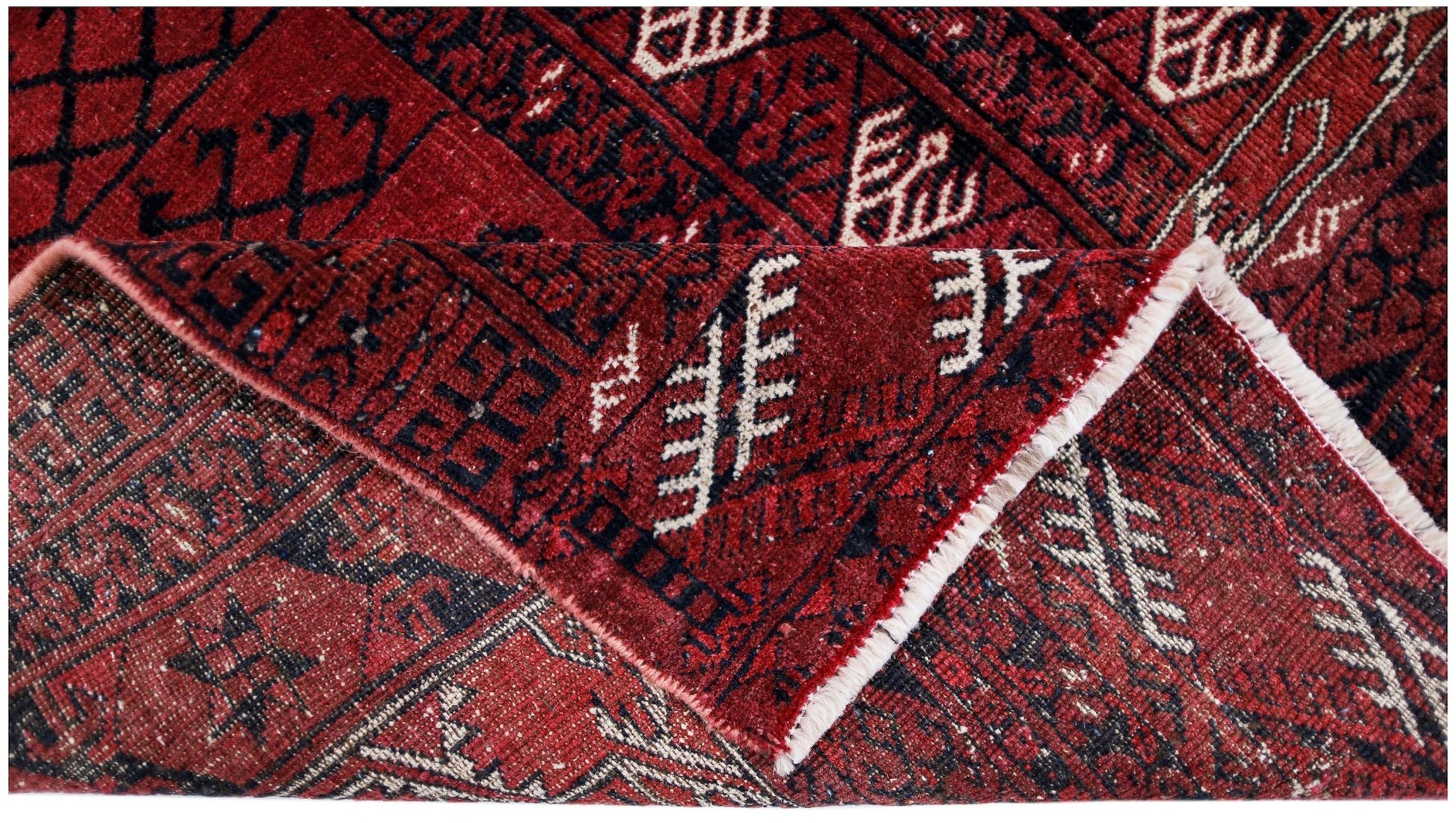A vintage Afghan Turkmen Engsi rug featuring geometric patterns in deep red, blue, and ivory.
