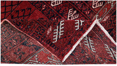 A vintage Afghan Turkmen Engsi rug featuring geometric patterns in deep red, blue, and ivory.