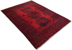 A handmade vintage Afghan Turkmen rug featuring a deep red field with repeating elephant foot motifs.