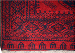 A vintage Afghan Turkmen rug featuring a deep red background with black geometric elephant foot motifs.