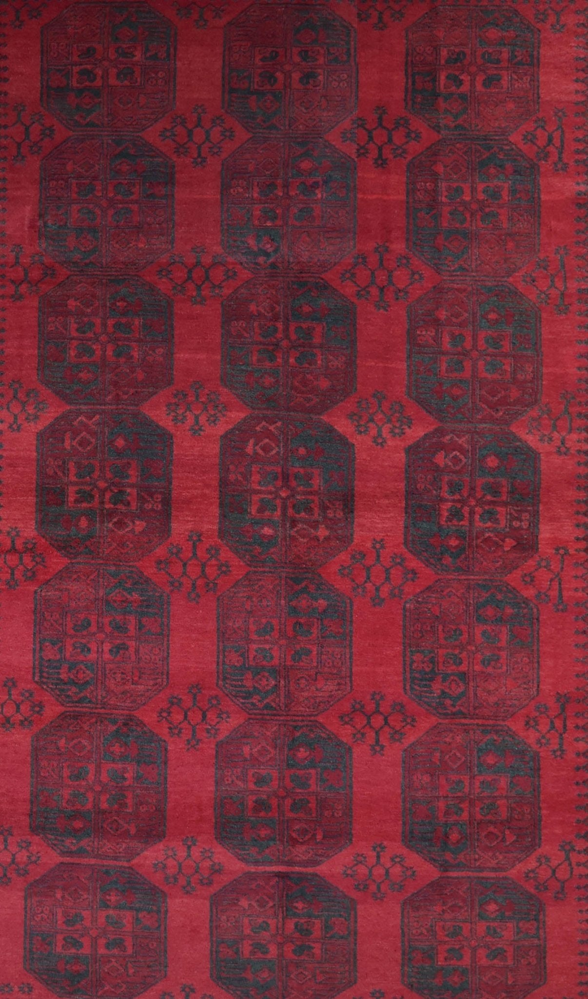 A vintage handmade Afghan Turkmen rug featuring a repeating geometric octagonal pattern in red.