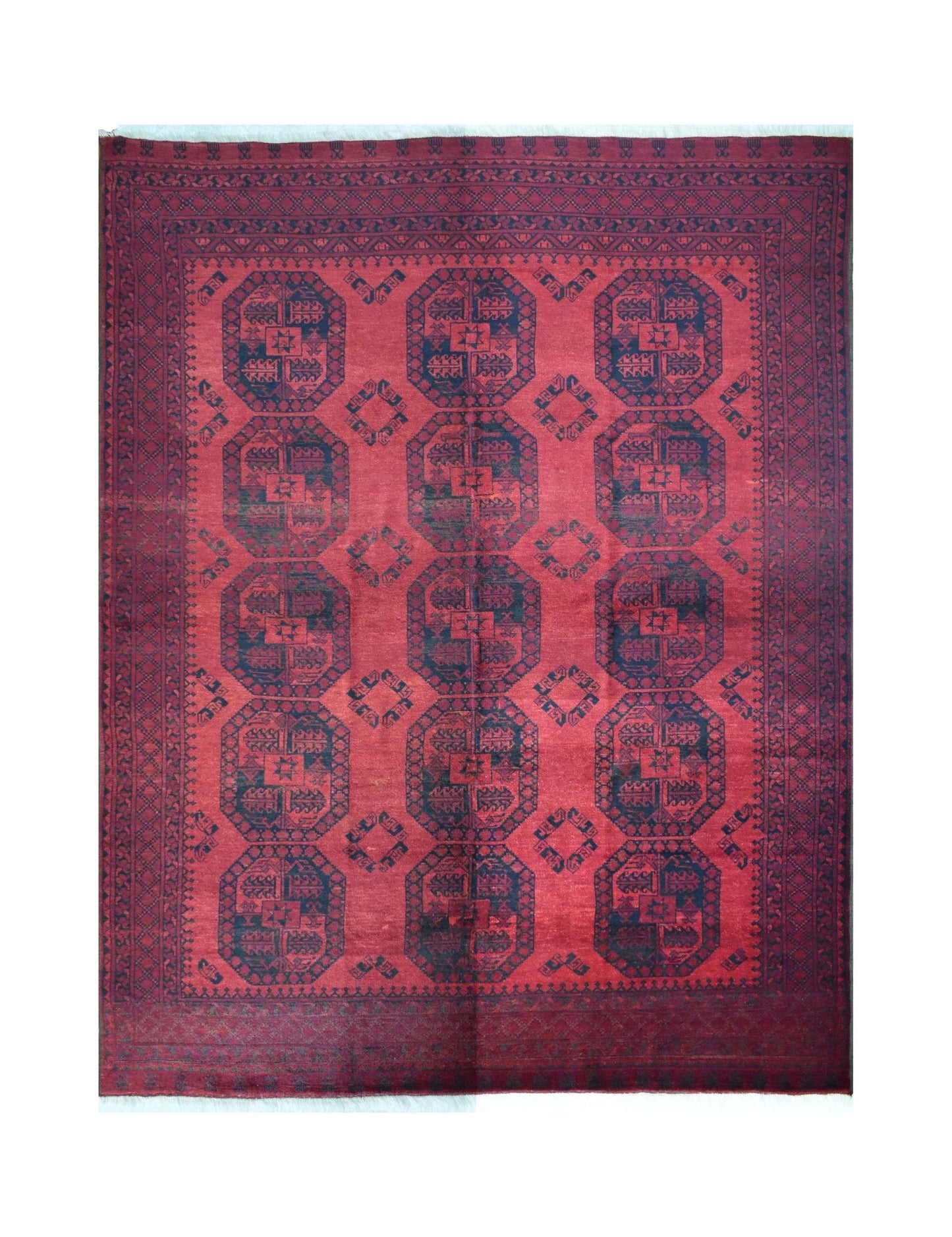 A vintage handmade Afghan Turkmen wool rug featuring a repeating geometric octagonal pattern.