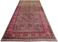 An antique handwoven Afghan Turkmen rug featuring a repeating pomegranate pattern in vibrant pink.