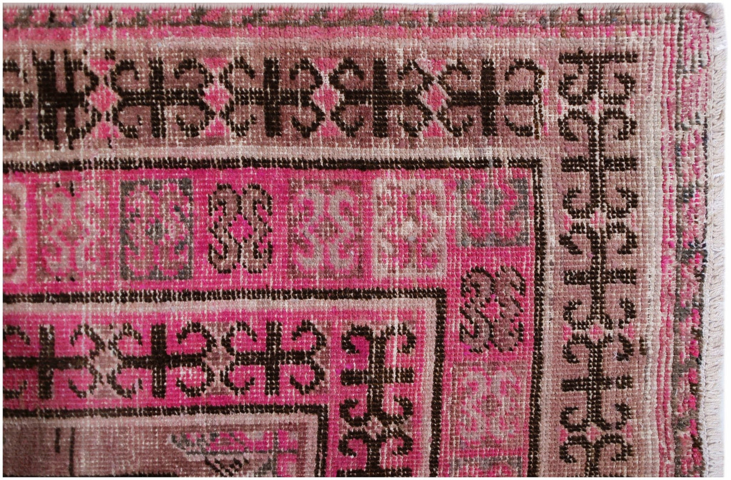 An antique handwoven Afghan rug featuring an intricate pomegranate pattern in vibrant pink.