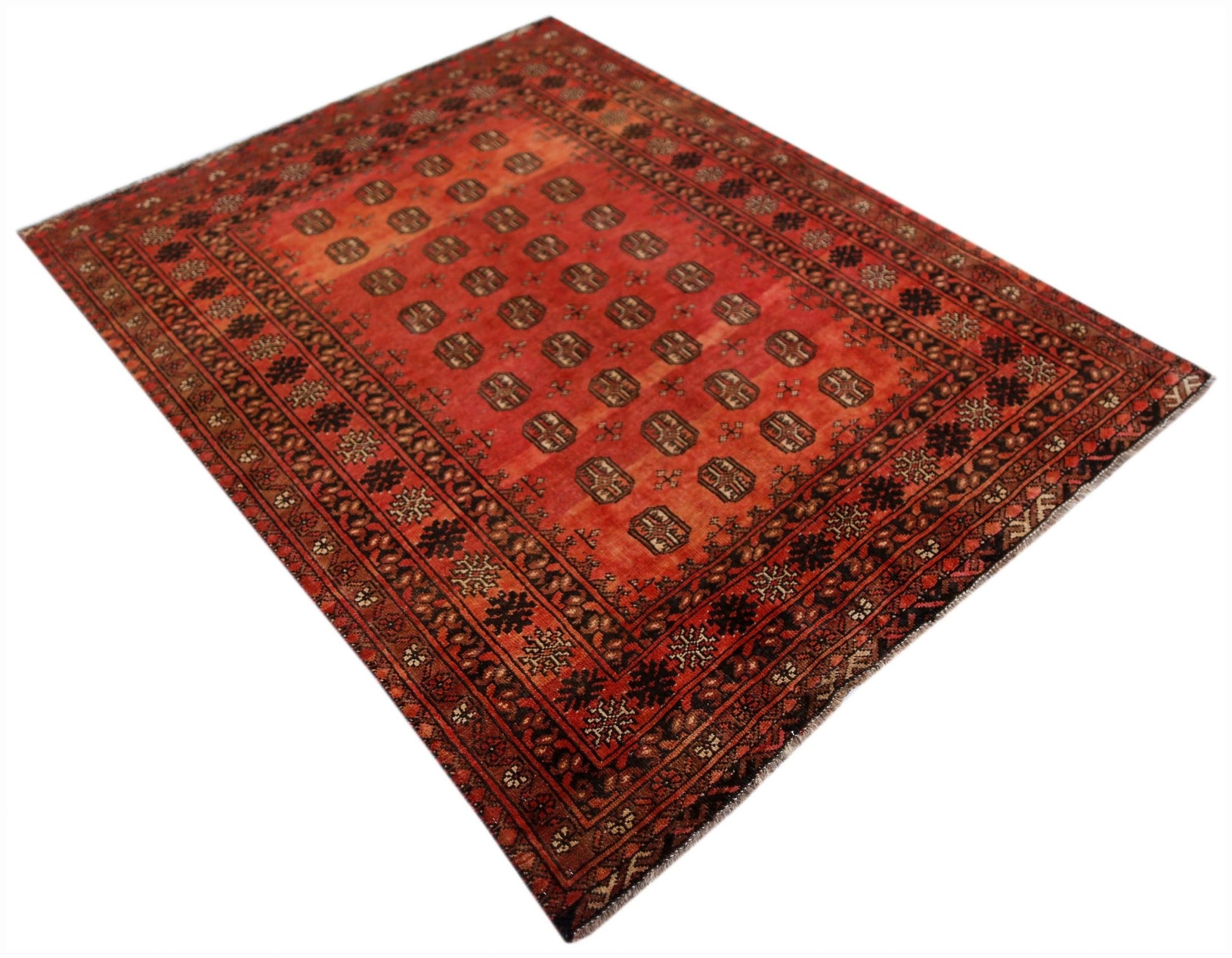 A vintage handwoven Afghan Turkmen rug featuring a repeating geometric pattern in shades of red.