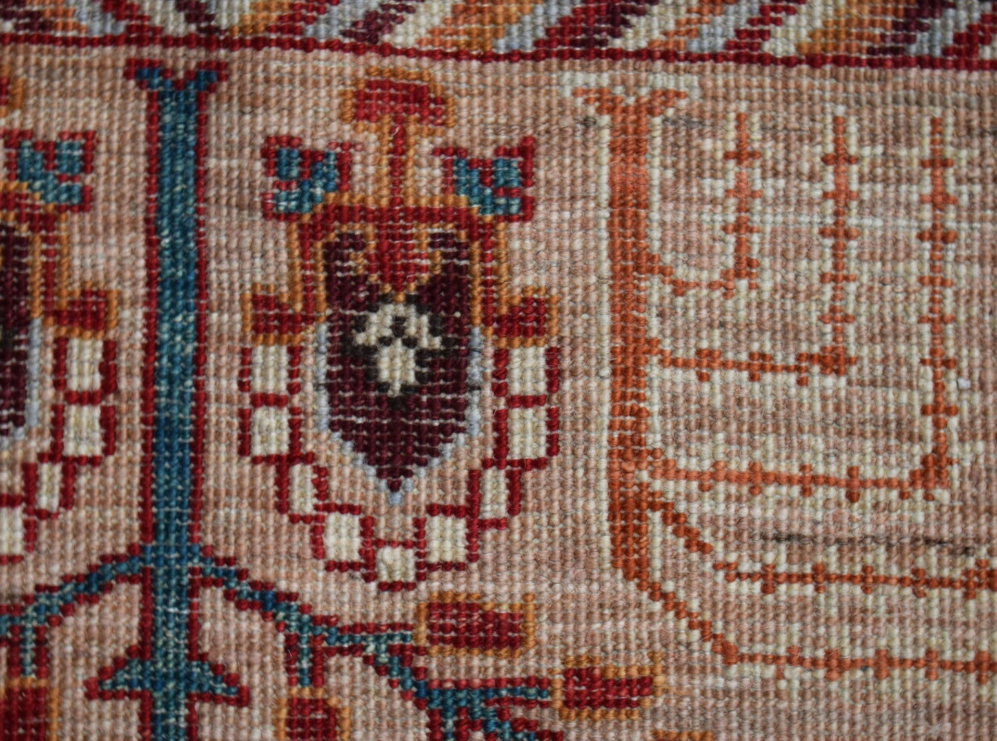 A close-up of a hand-knotted Afghan Chobi runner featuring a traditional tree of life motif.