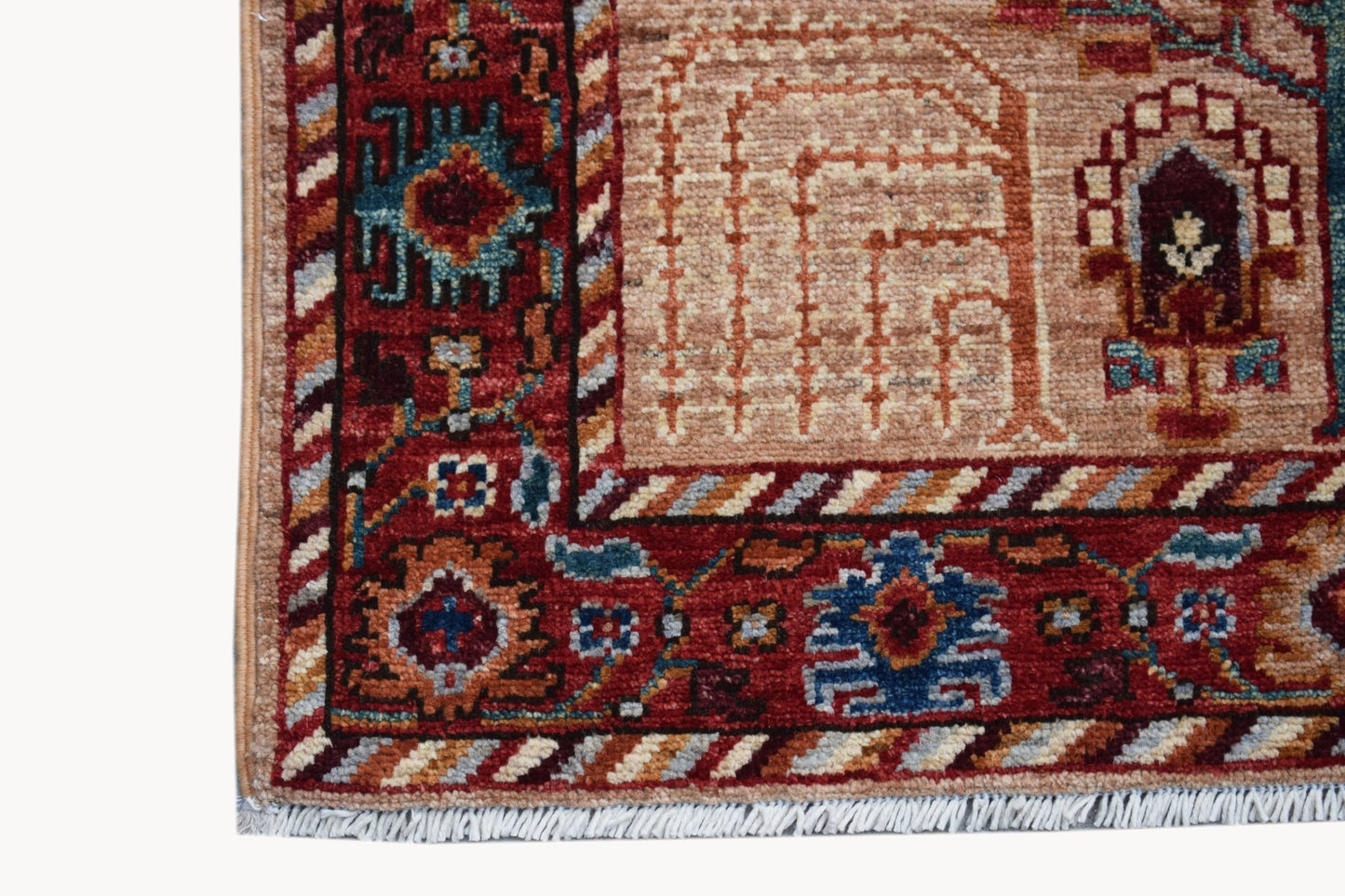 A close-up of an Afghan Chobi runner featuring a red border with intricate floral and geometric motifs.