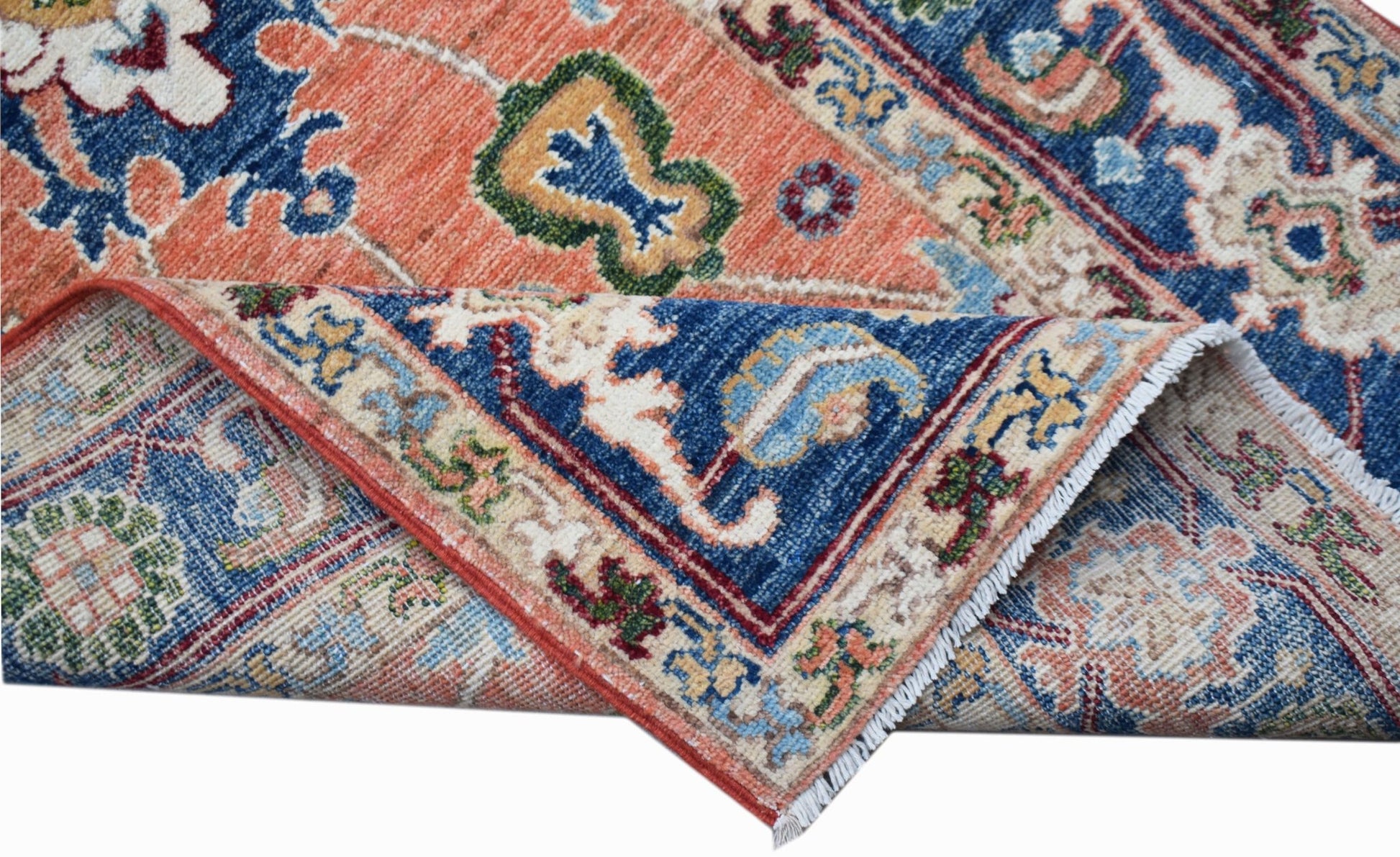 A hand-knotted Afghan Chobi runner featuring traditional floral patterns in blue and orange tones.