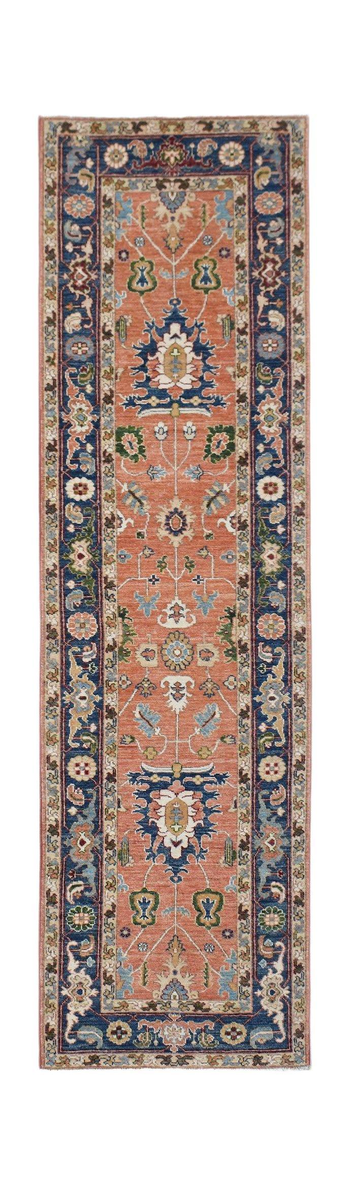 A handmade Afghan Chobi runner rug featuring a traditional floral pattern in terracotta and blue.