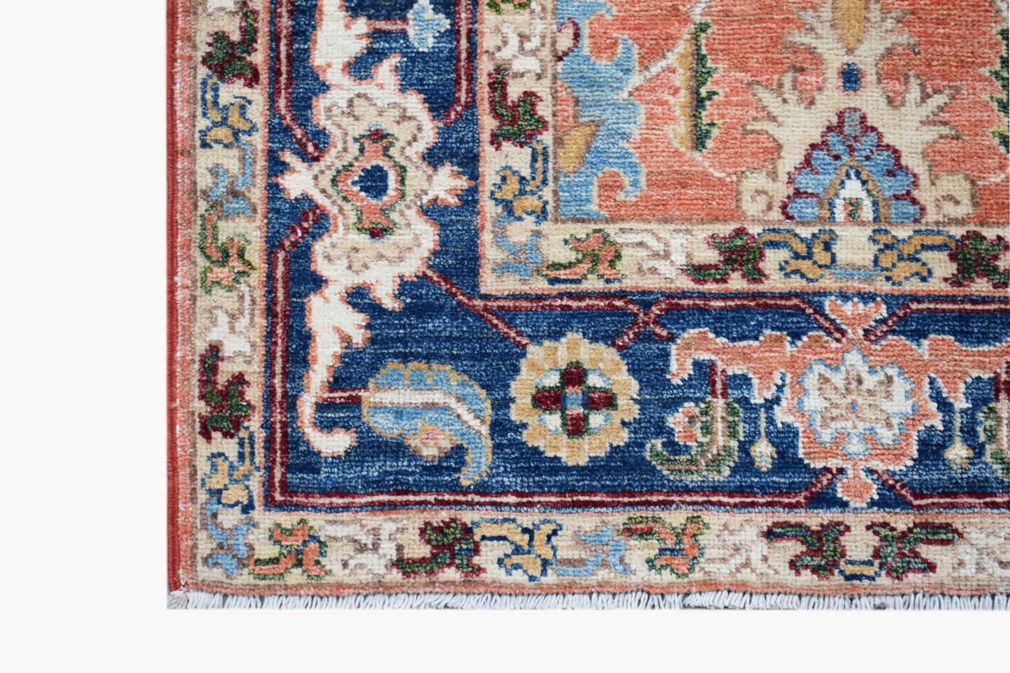 A corner view of a hand-knotted Afghan Chobi runner featuring traditional floral patterns.