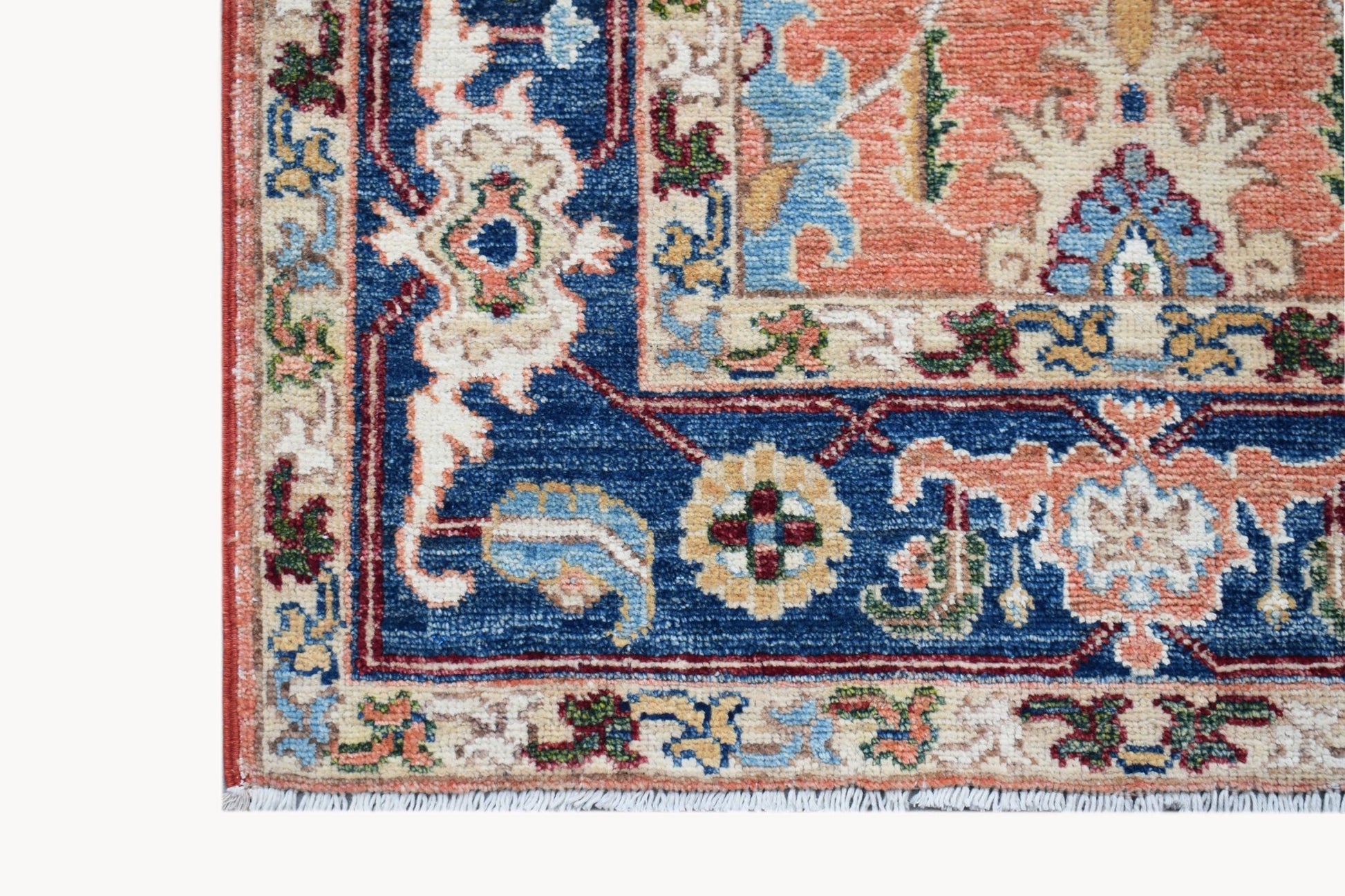 A corner view of a hand-knotted Afghan Chobi runner featuring traditional floral patterns.