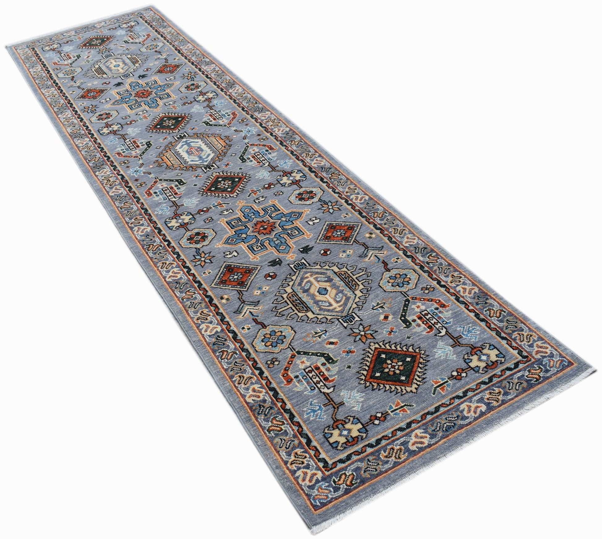 A hand-knotted Afghan Chobi runner rug featuring traditional geometric patterns in blue tones.