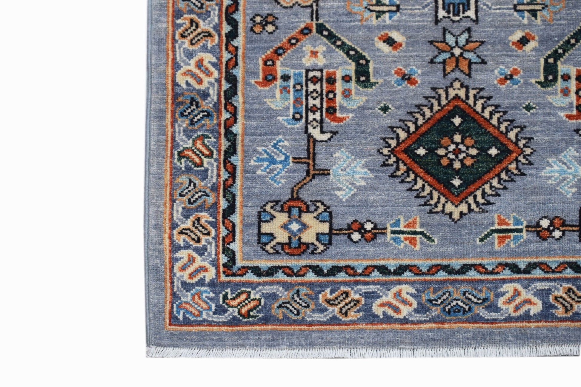 A handmade Afghan Chobi runner featuring a blue field with traditional geometric patterns.
