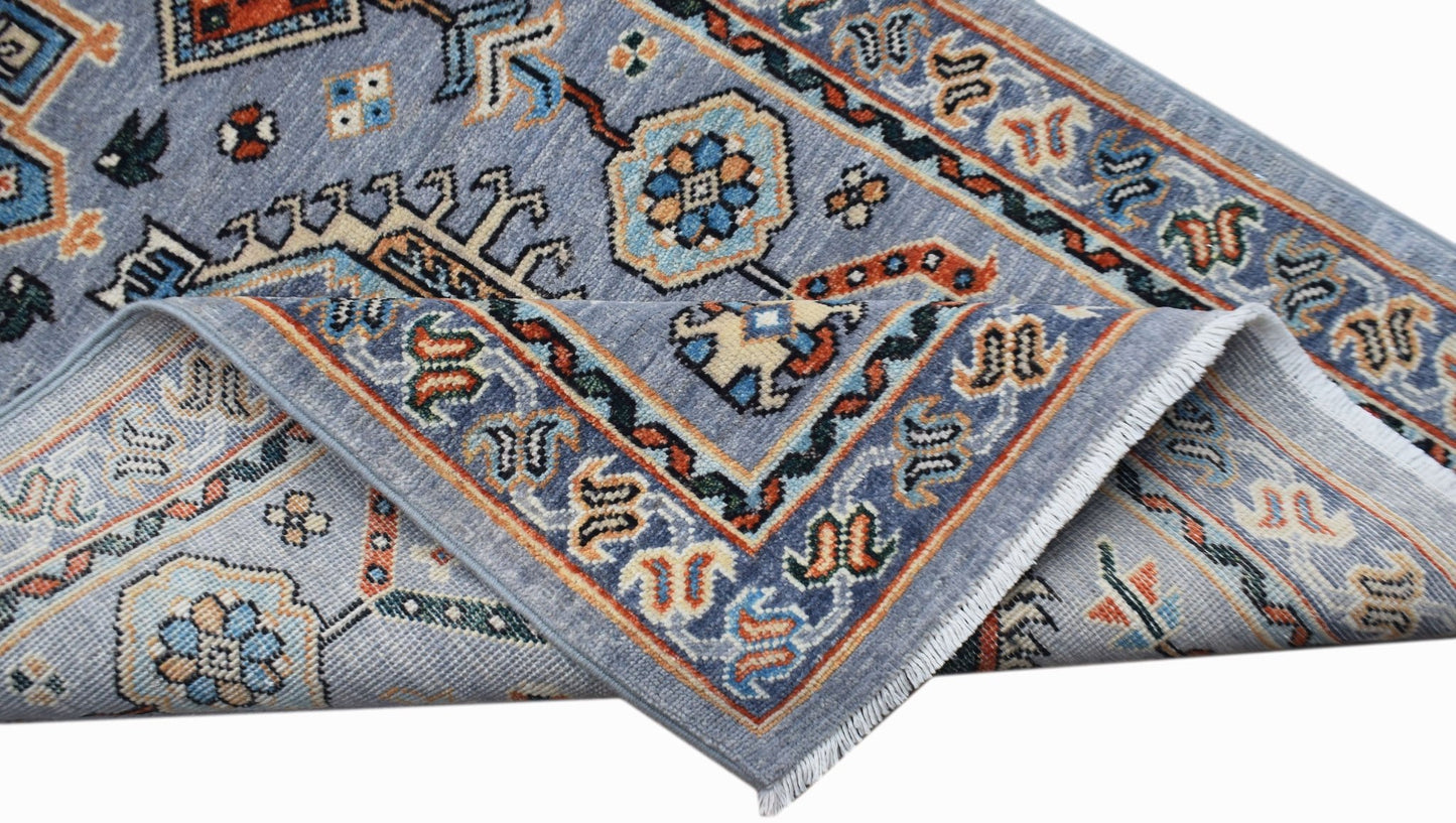 A hand-knotted Afghan Chobi runner featuring traditional floral patterns in blue and orange tones.
