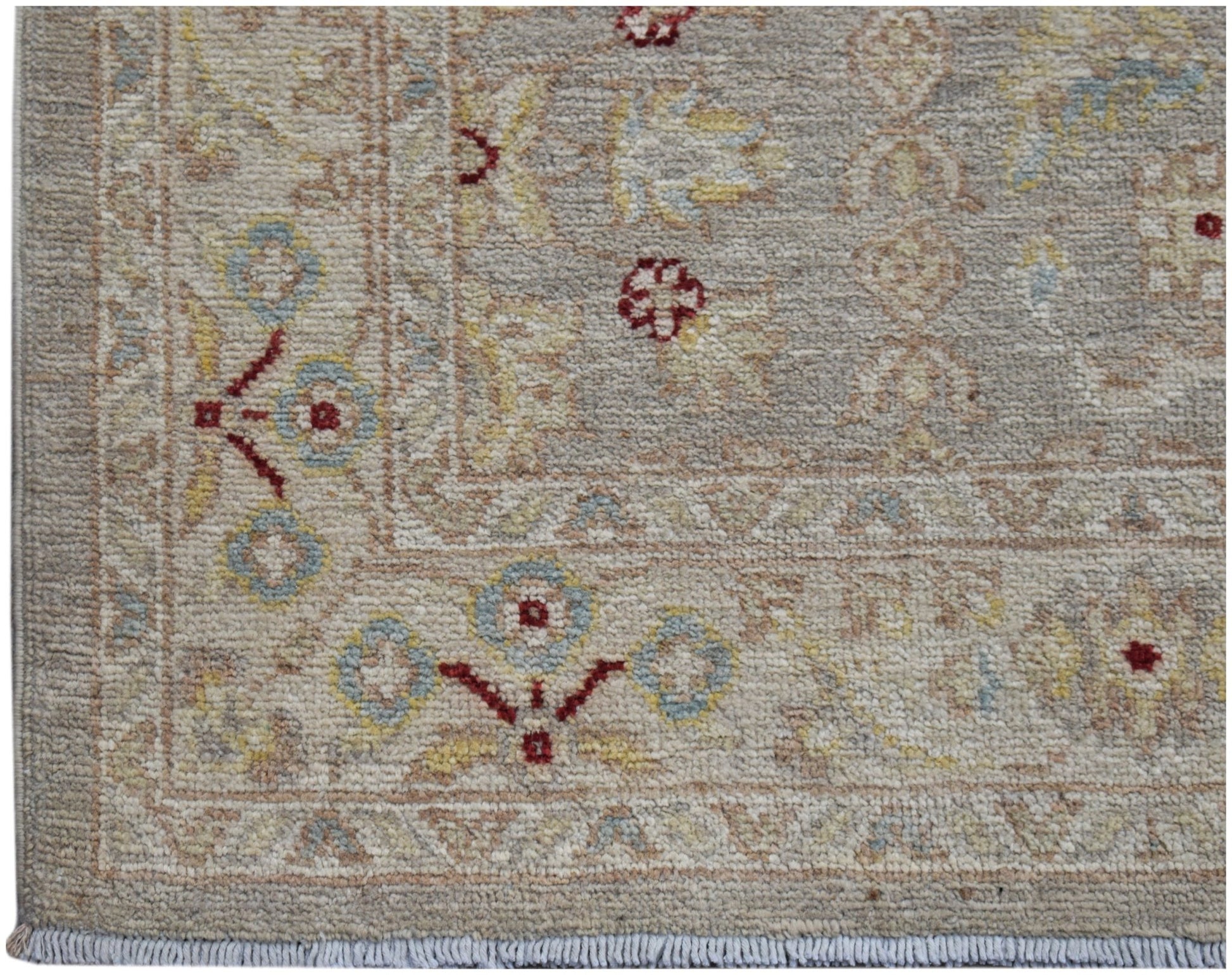 A hand-knotted Afghan Chobi runner featuring traditional floral patterns in soft, earthy tones.