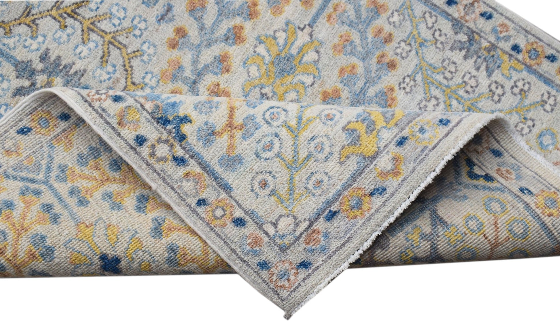 A hand-knotted Afghan Chobi runner featuring a traditional floral pattern in blue, yellow, and tan.