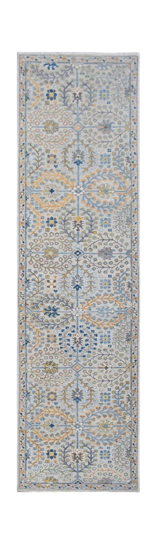 An Afghan Chobi runner rug featuring a traditional floral pattern in blue, gold, and cream tones.