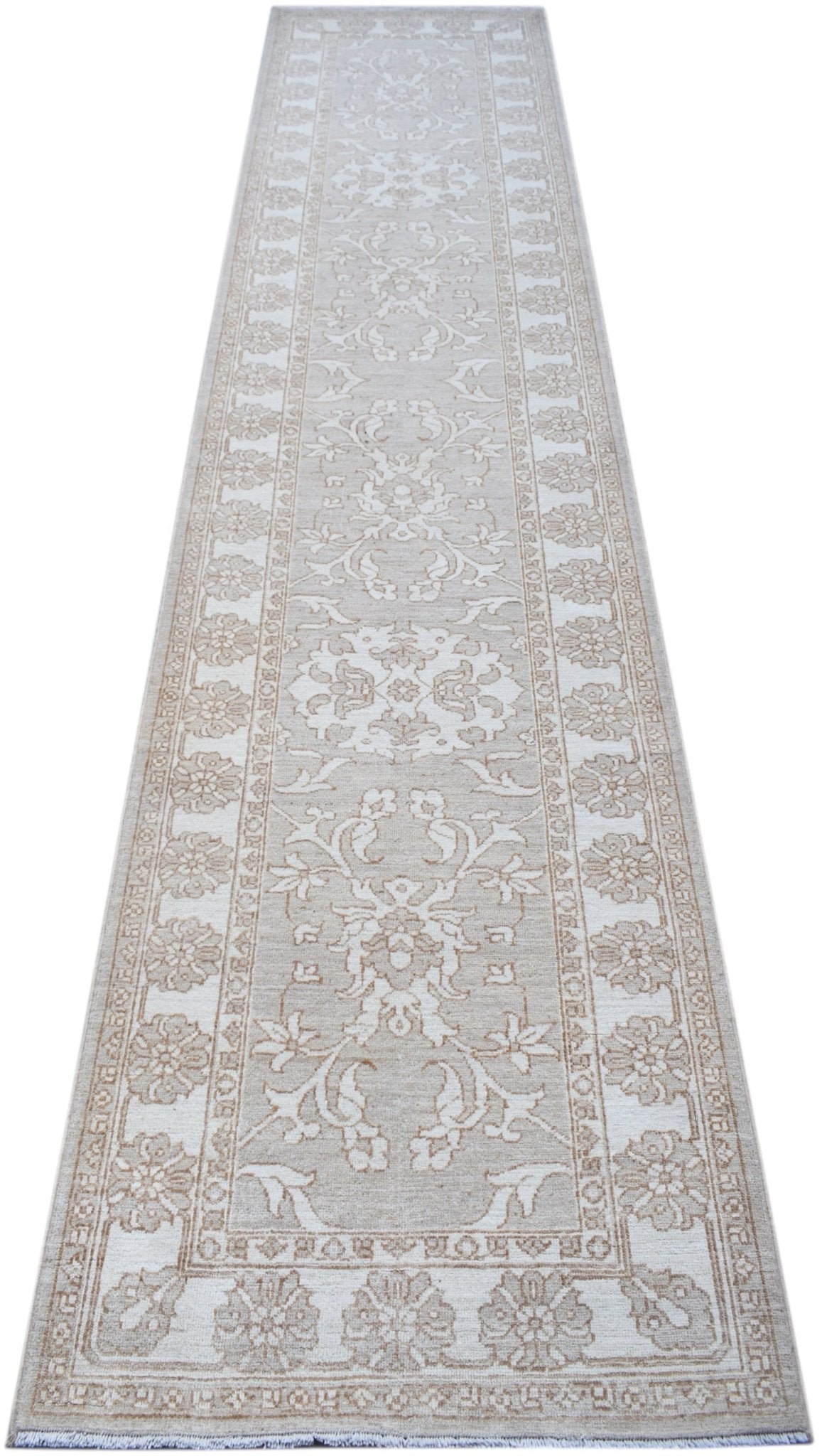 A handmade Afghan Chobi runner rug featuring a traditional floral pattern in neutral beige tones.