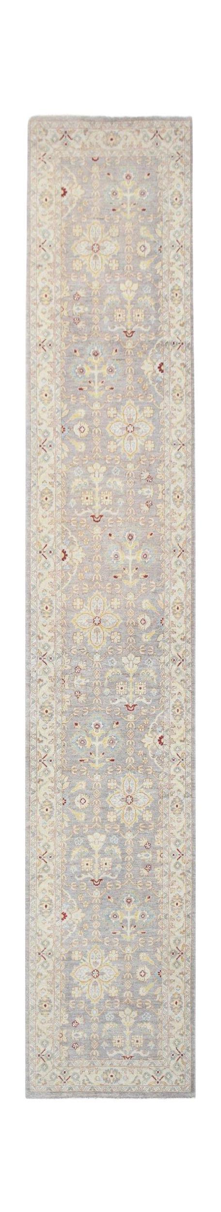 A handwoven Afghan Chobi runner rug featuring traditional floral patterns in soft neutral tones.