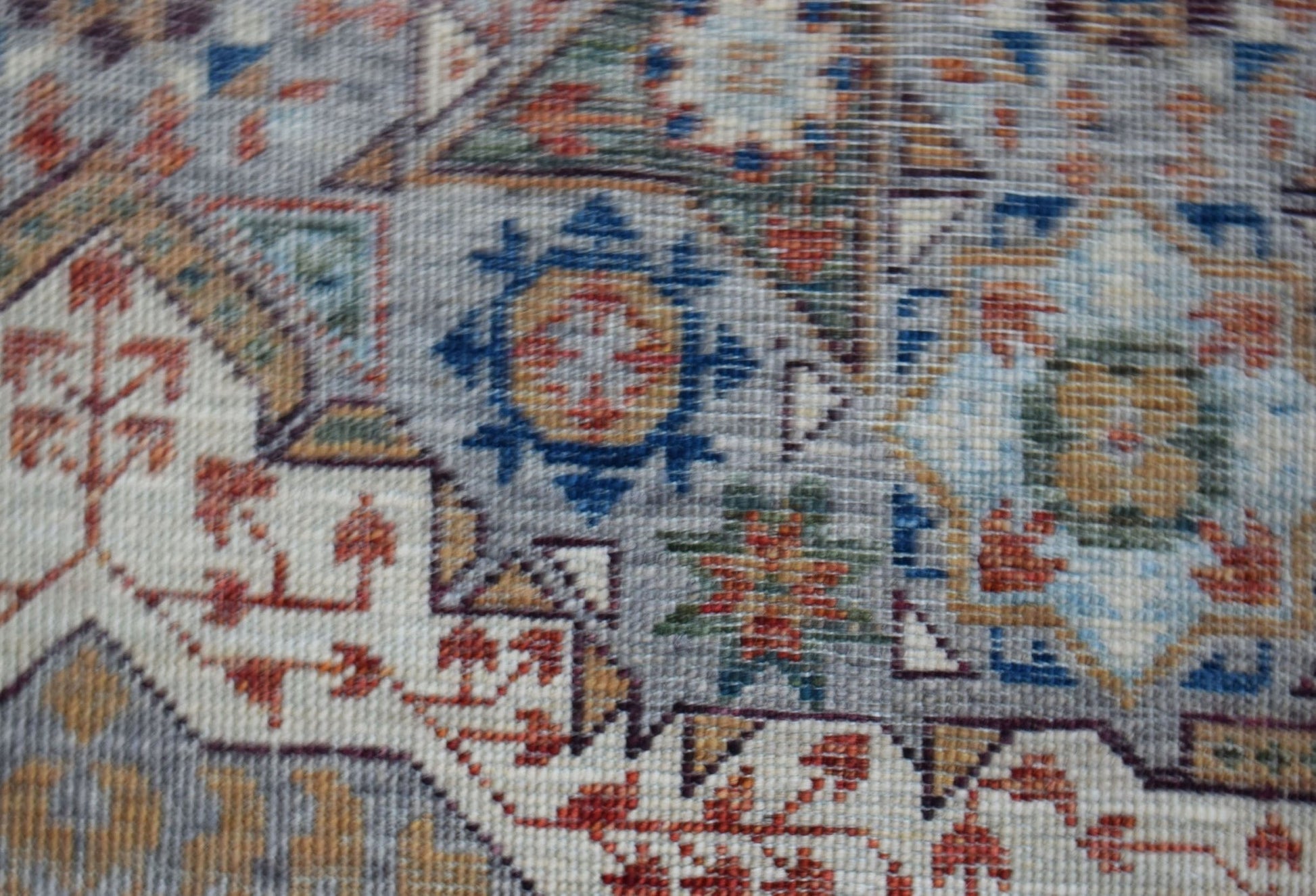 A close-up of a handwoven Afghan Chobi runner featuring a detailed Mamluk medallion pattern.