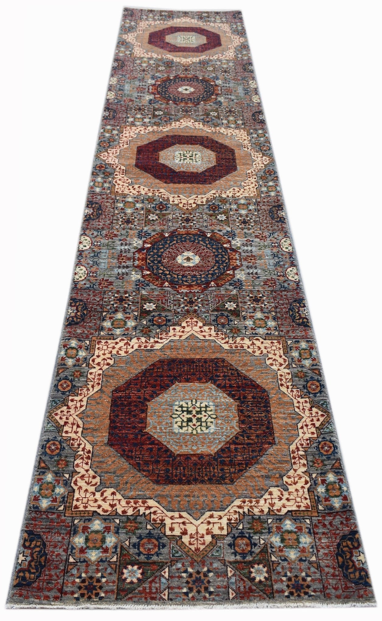 A handmade Afghan Chobi runner rug featuring a traditional Mamluk medallion pattern.