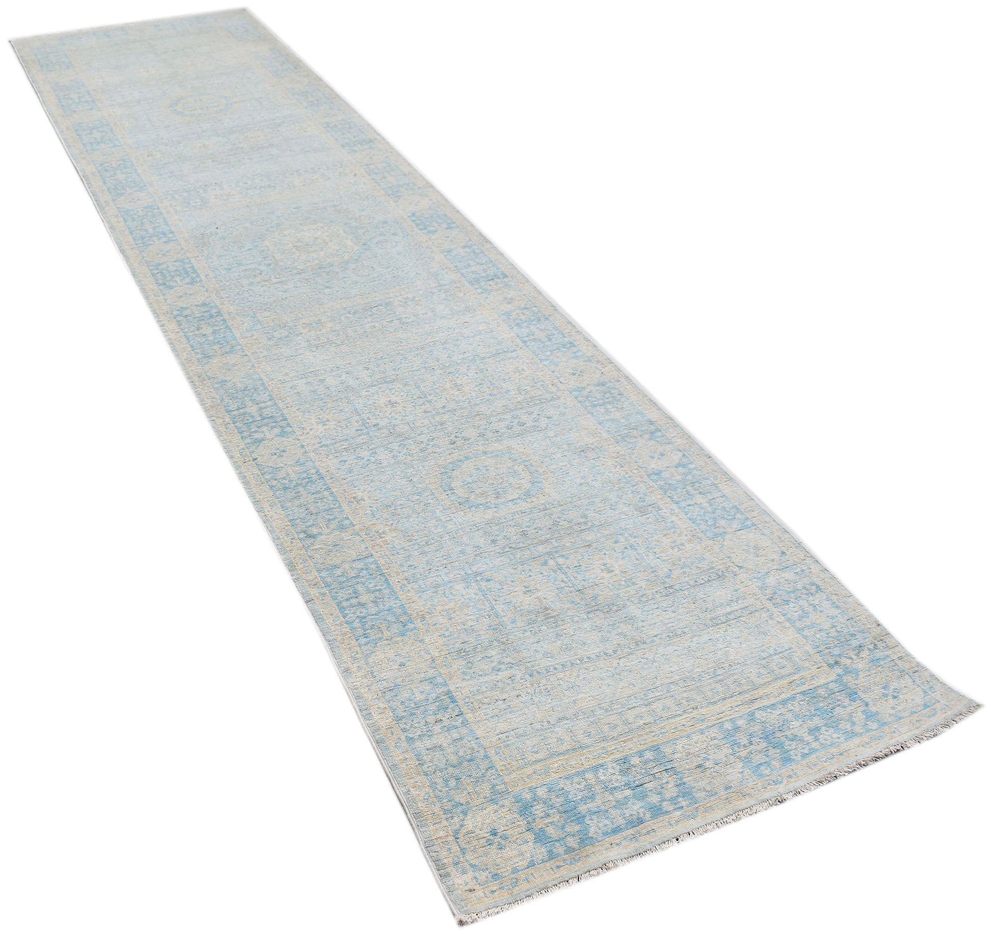 A handwoven Afghan Chobi runner rug featuring a light blue and cream Mamluk medallion pattern.