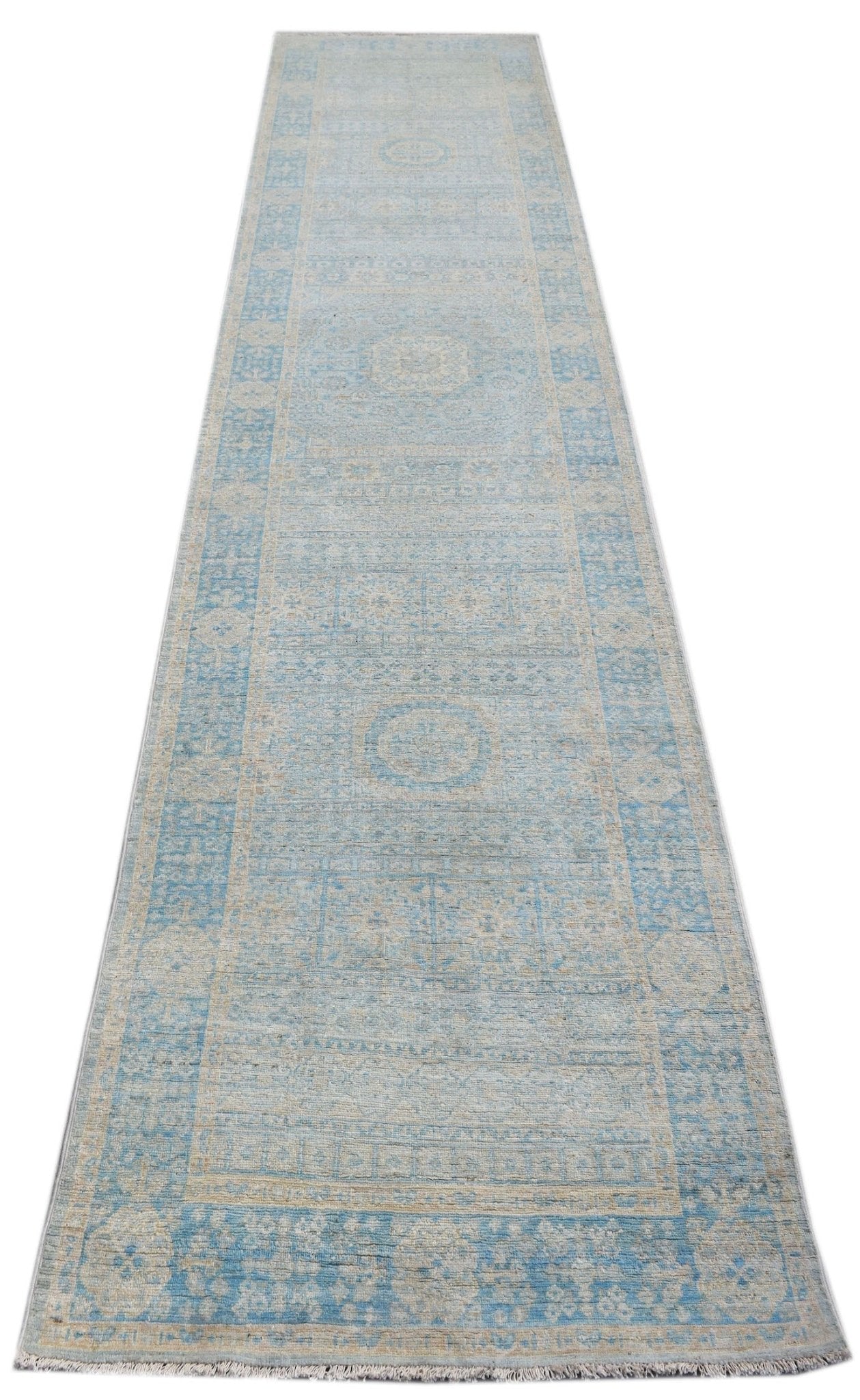 A handwoven Afghan Chobi runner rug featuring a light blue and beige Mamluk medallion pattern.