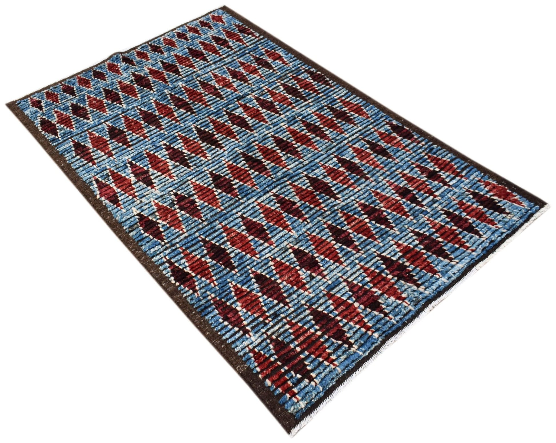 An Afghan Yekta rug featuring a blue background with repeating red and dark geometric diamond motifs.