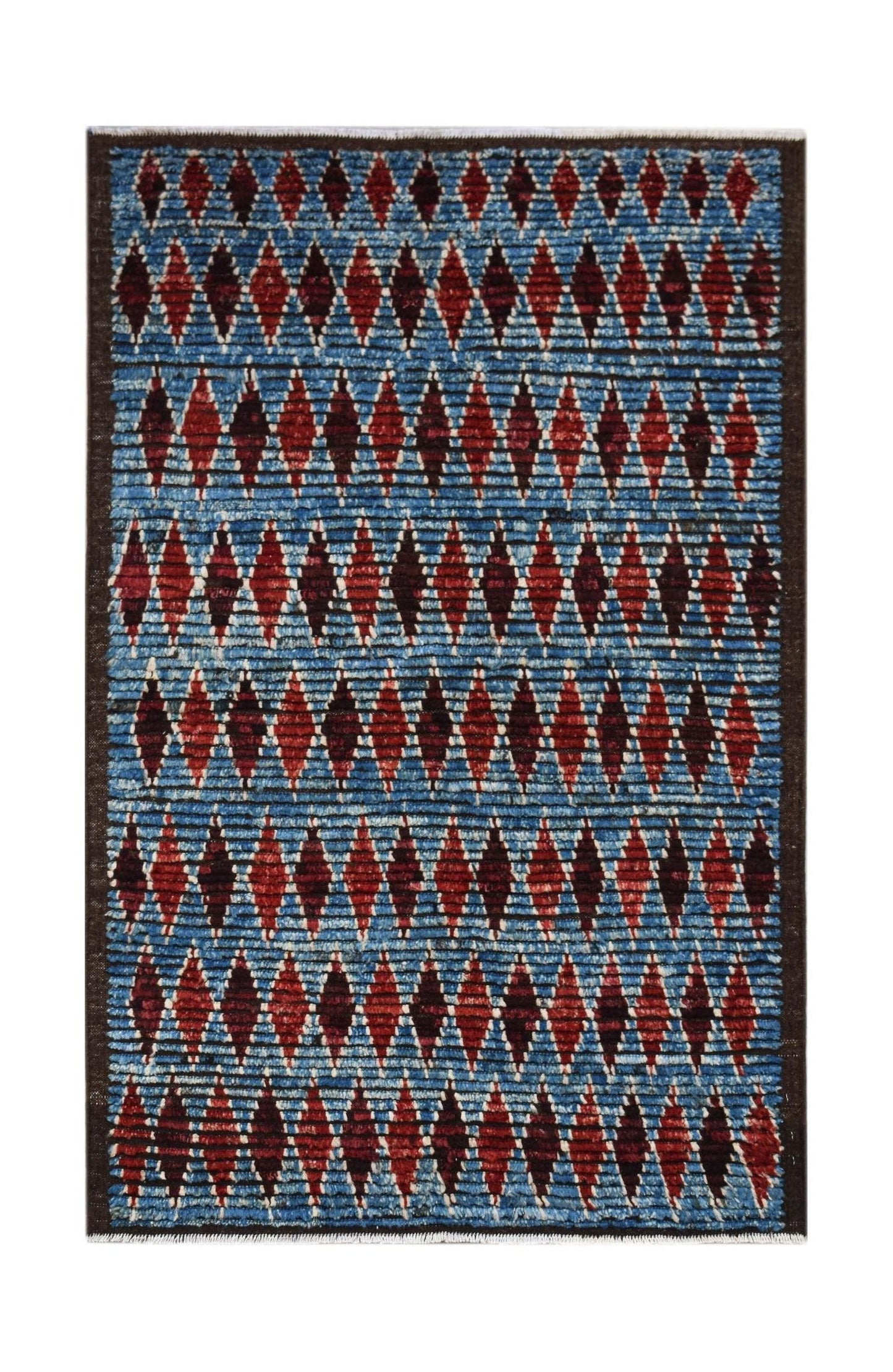 Hand-knotted Afghan rug featuring a blue background with repeating red diamond patterns.