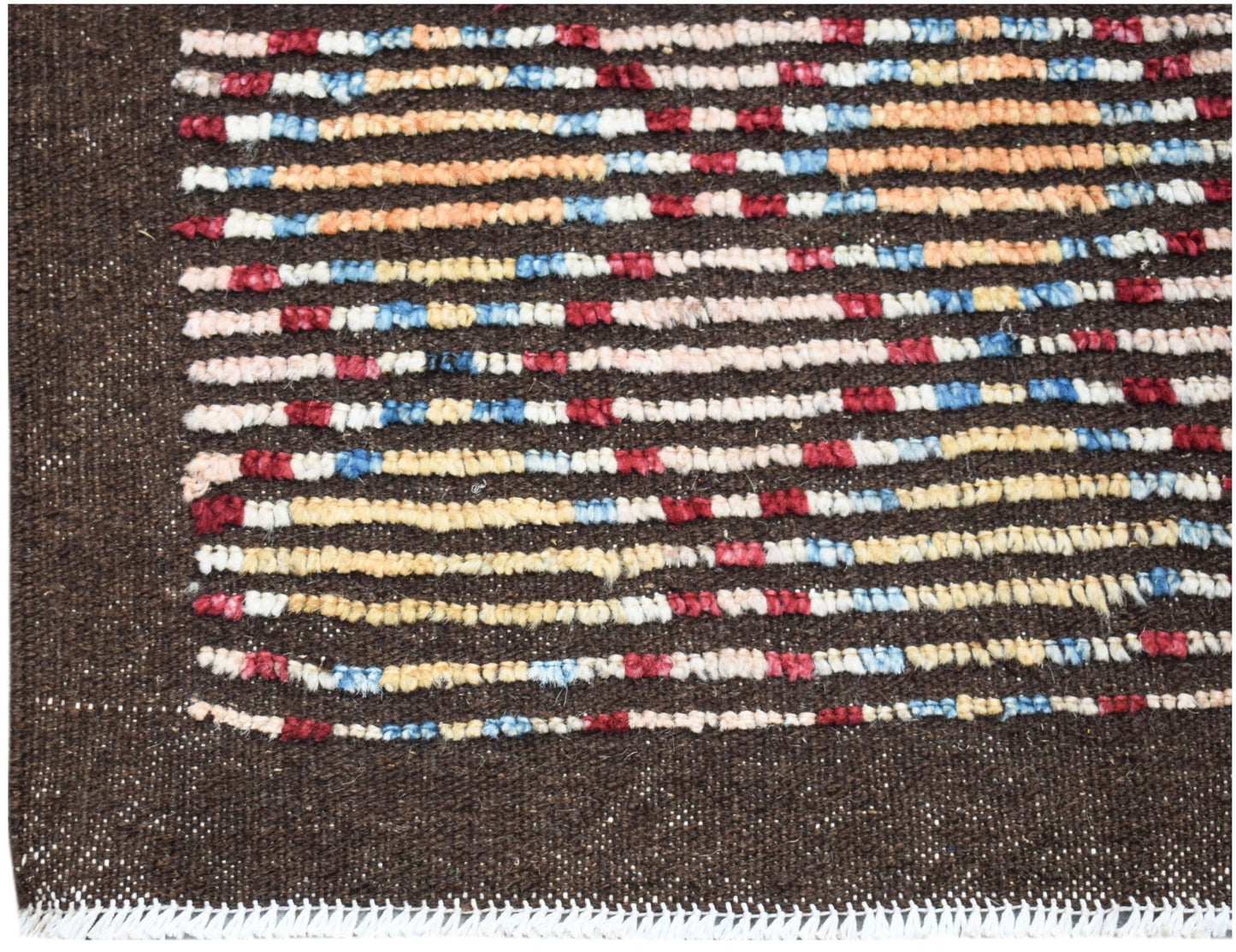 A hand-knotted Afghan rug featuring horizontal stripes of red, blue, and yellow on a brown field.