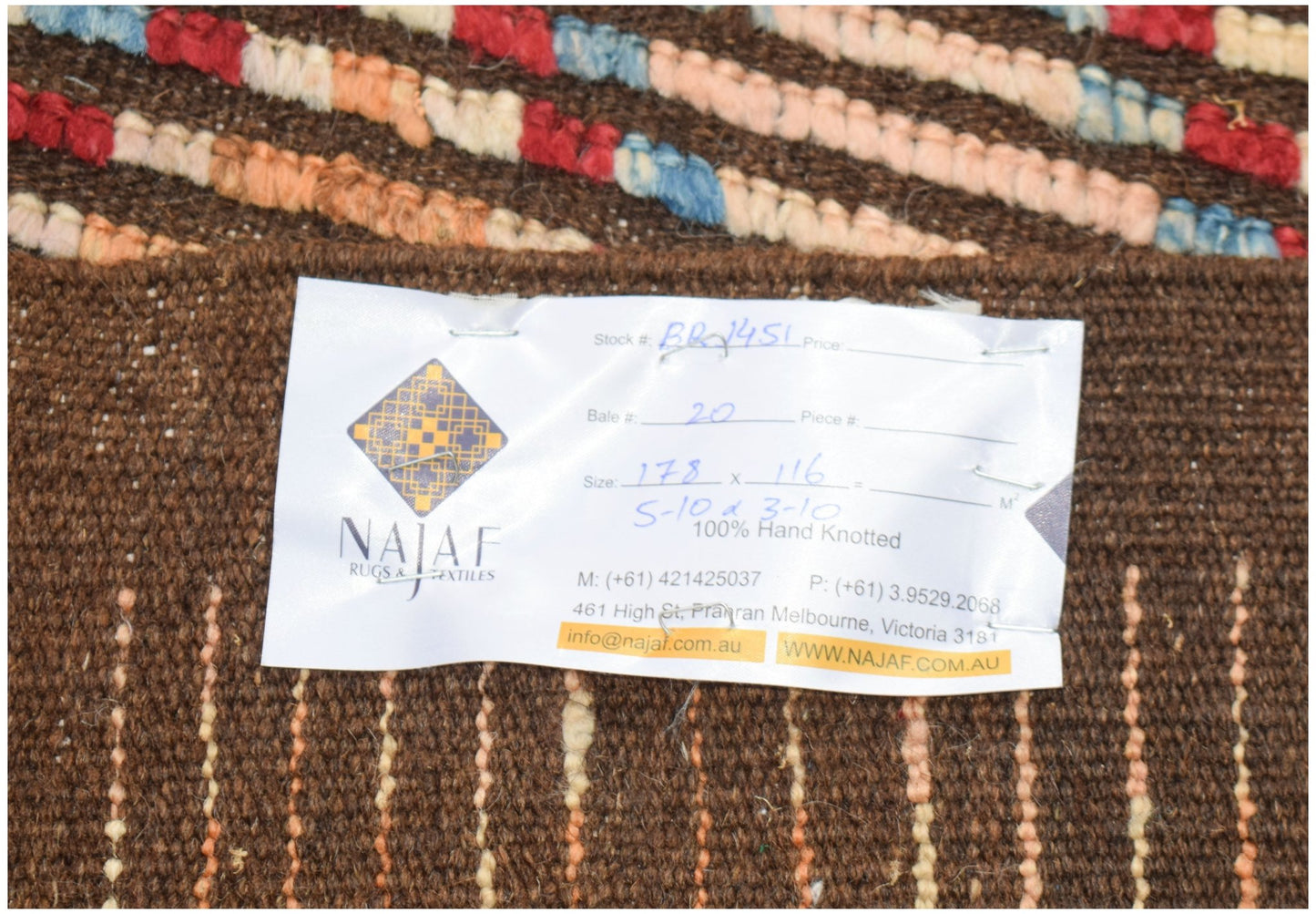 A hand-knotted Afghan Yekta rug featuring a brown base with colorful geometric patterns.