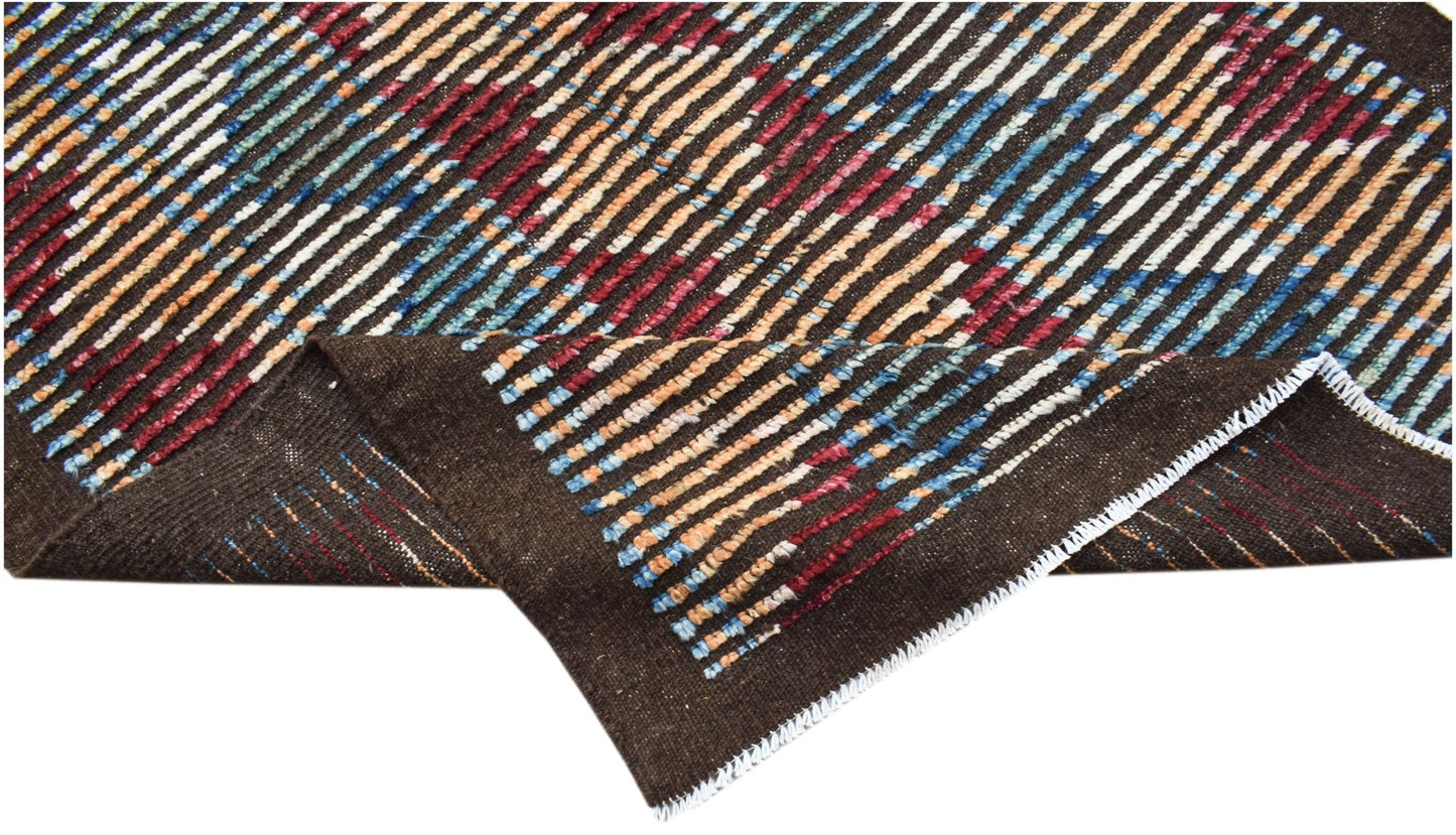 An Afghan Yekta rug featuring a dark brown base with colorful, hand-knotted striped patterns.