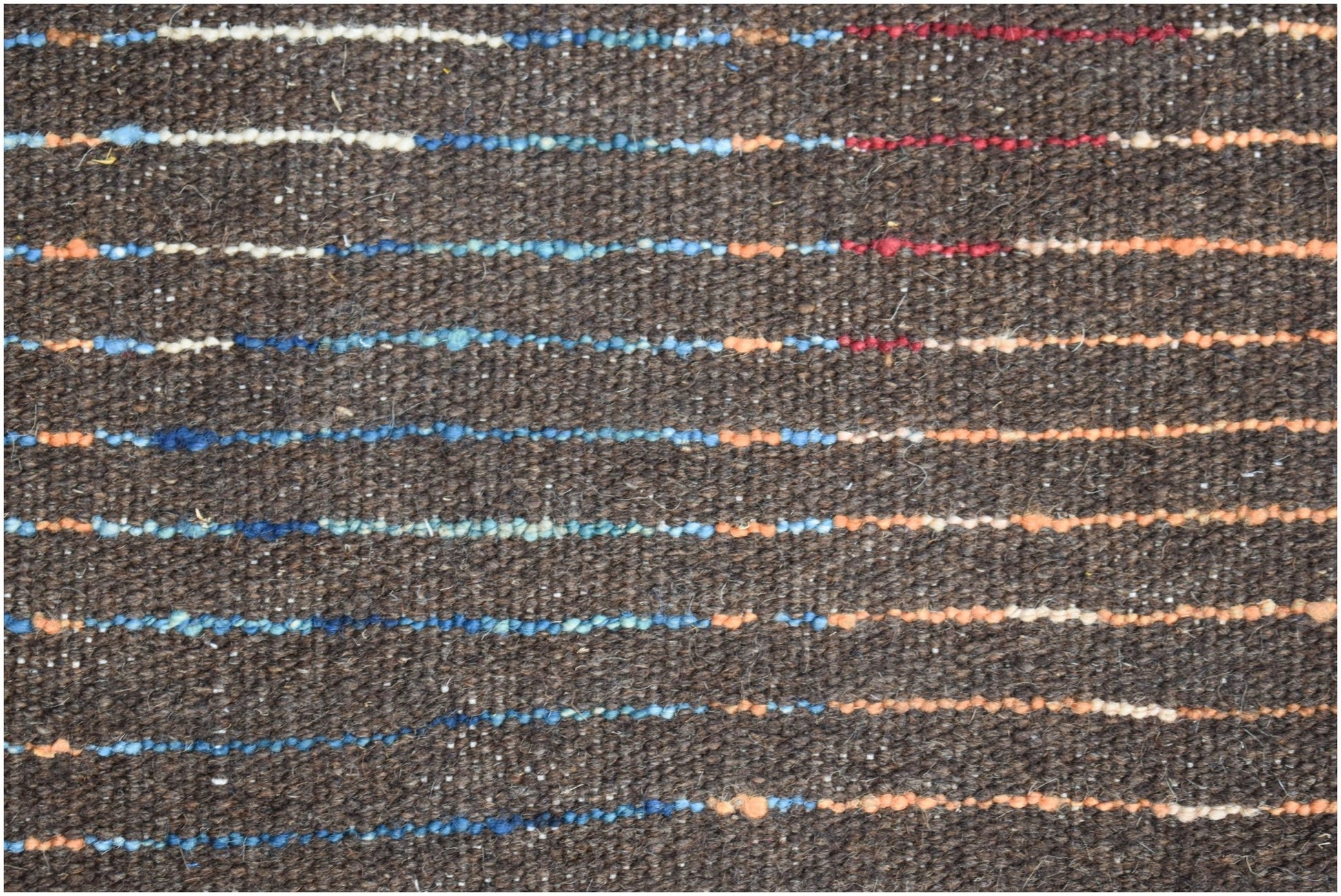 A dark brown hand-knotted Afghan wool rug featuring horizontal stripes of blue, red, and orange.