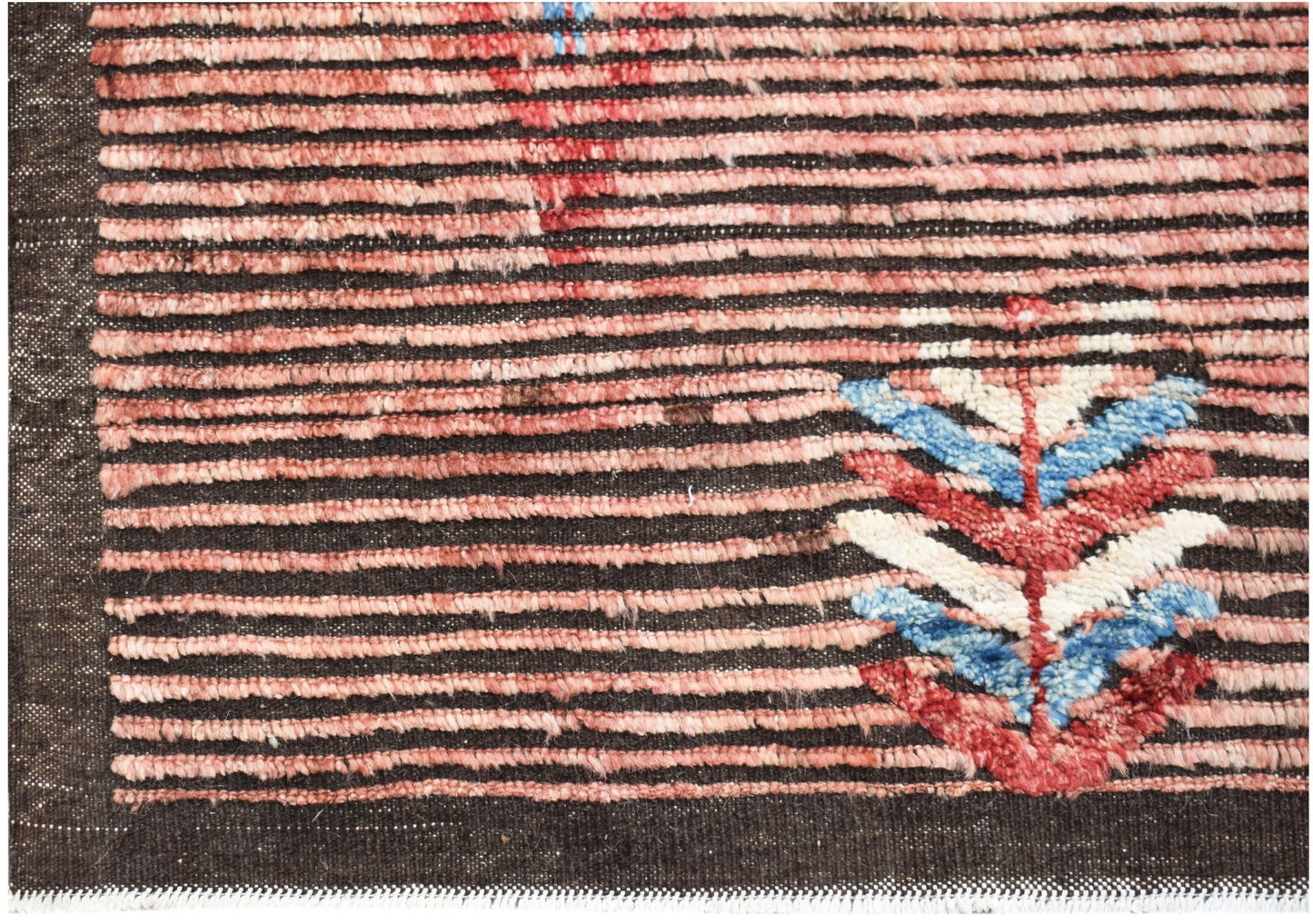Hand-knotted Afghan rug with horizontal pink stripes and a colorful geometric leaf motif.