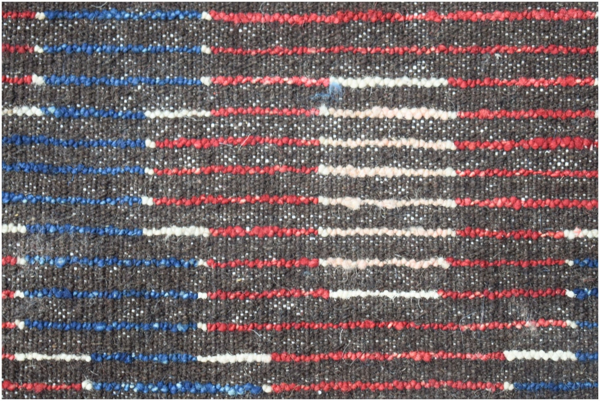 A hand-knotted Afghan rug featuring a dark brown base with horizontal stripes of red, blue, and cream.