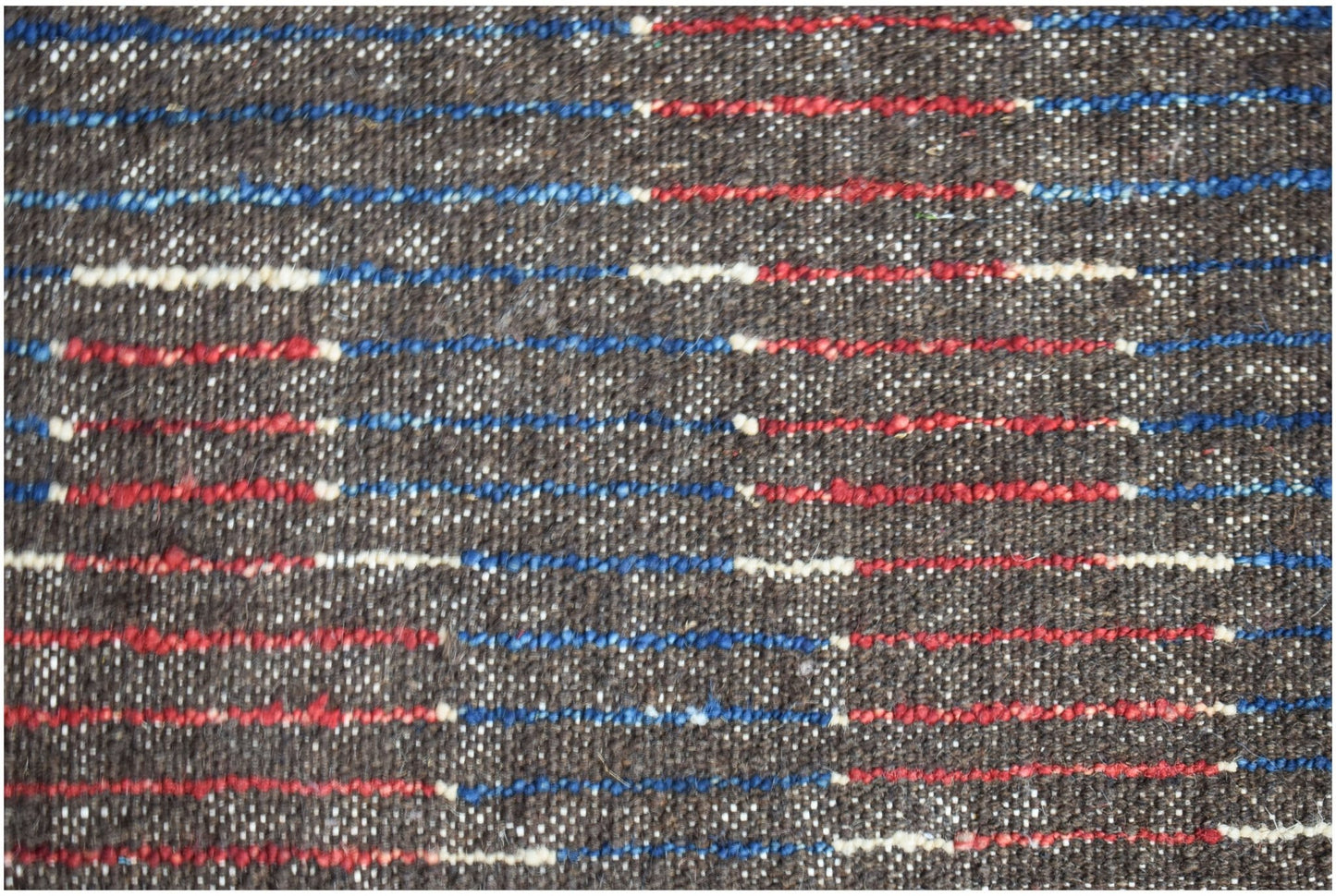 A hand-knotted Afghan rug featuring a dark brown wool base with horizontal red and blue stripes.