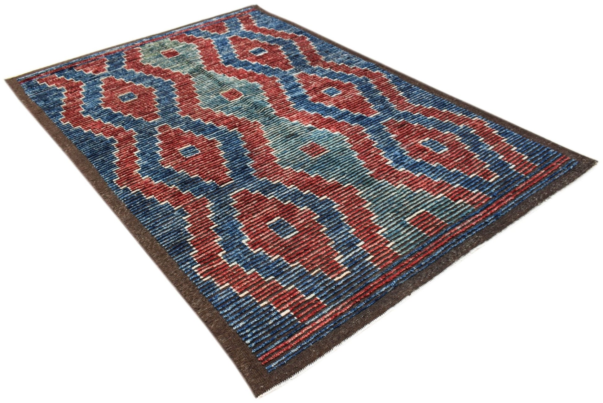 An Afghan Yekta rug featuring a geometric pattern in shades of red, blue, and teal.