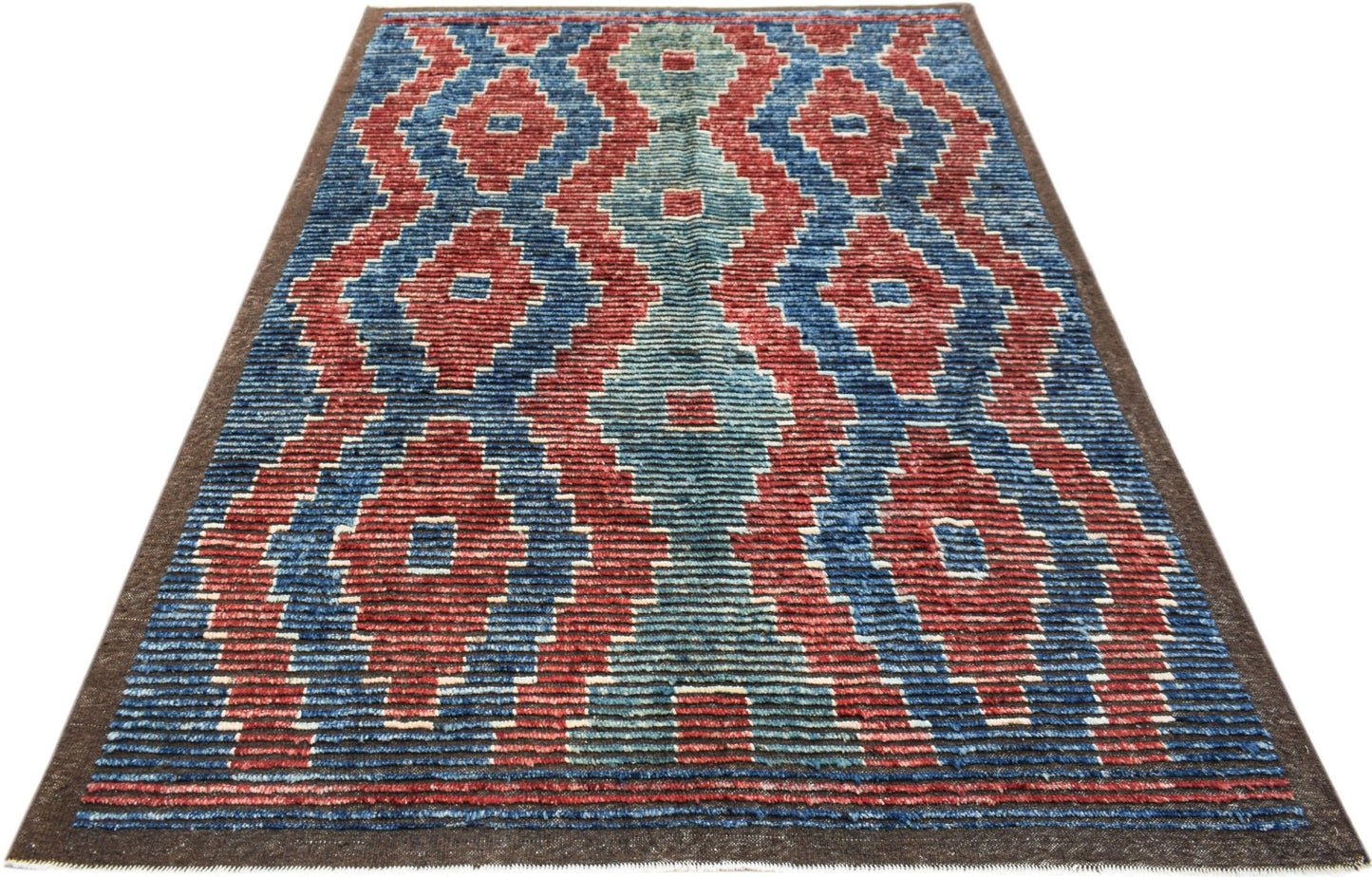 Hand-knotted Afghan Yekta rug featuring a bold geometric pattern in red, blue, and teal wool.
