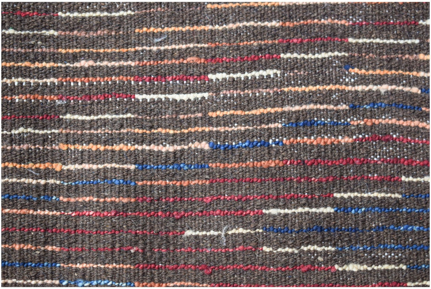 A hand-knotted Afghan rug featuring a dark brown wool base with horizontal multicolored stripes.