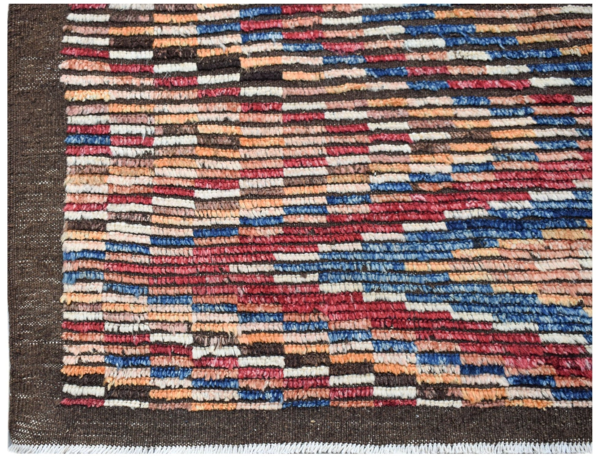 Hand-knotted Afghan rug featuring a multicolored geometric pattern on a dark brown background.