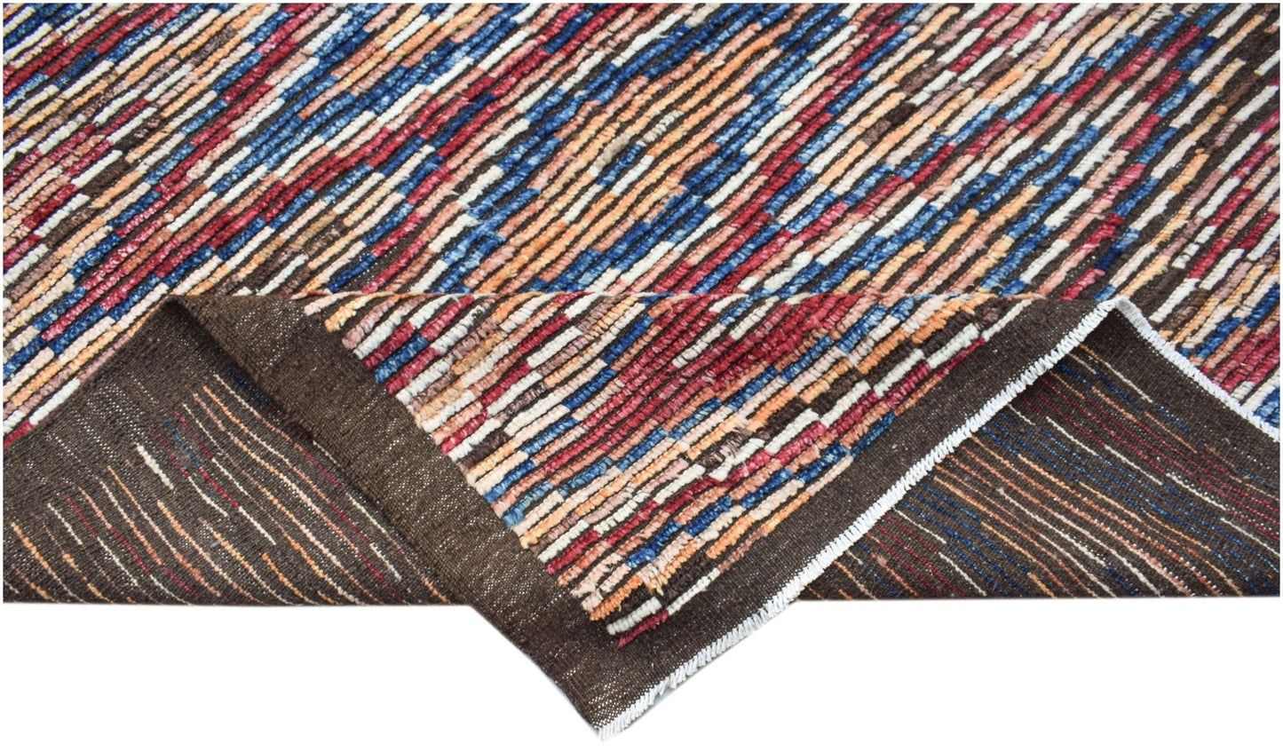 An Afghan Yekta rug featuring a multicolored striped pattern in hand-spun wool.