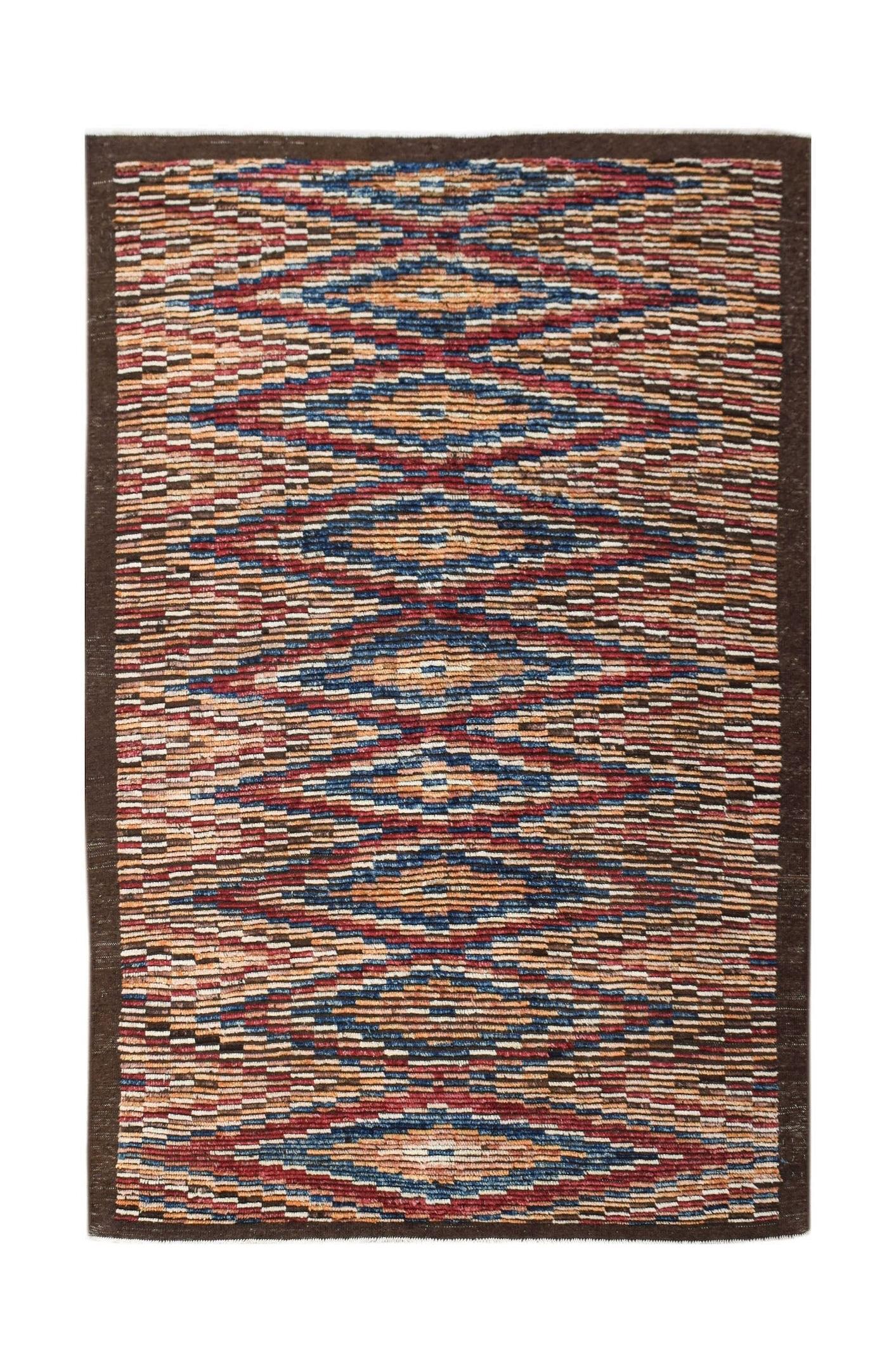 Hand-knotted Afghan rug featuring a repeating geometric diamond pattern in warm, earthy tones.