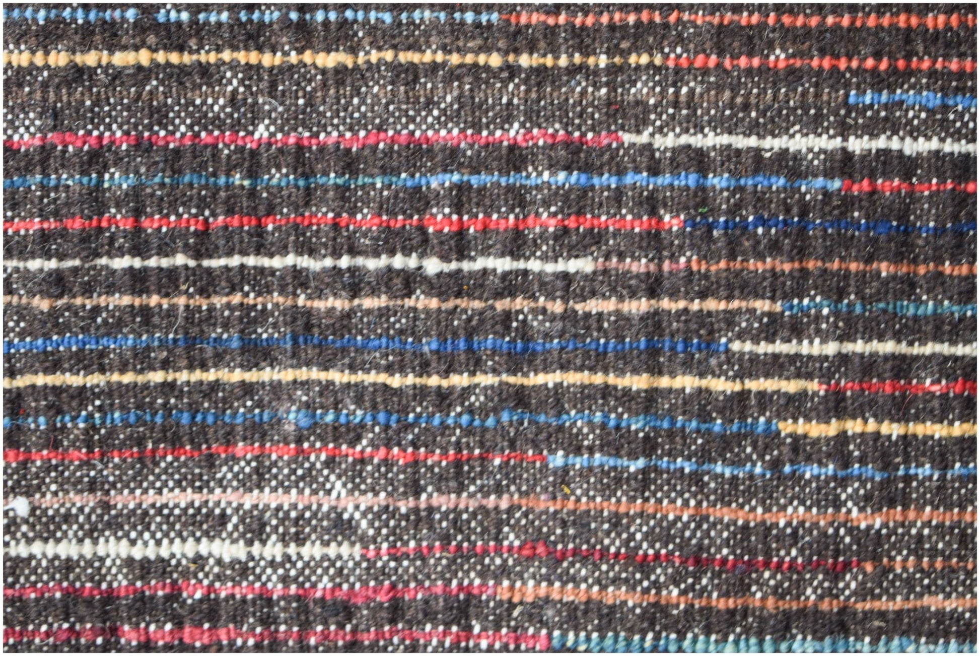 A hand-knotted Afghan rug featuring a dark brown base with horizontal stripes in vibrant colors.