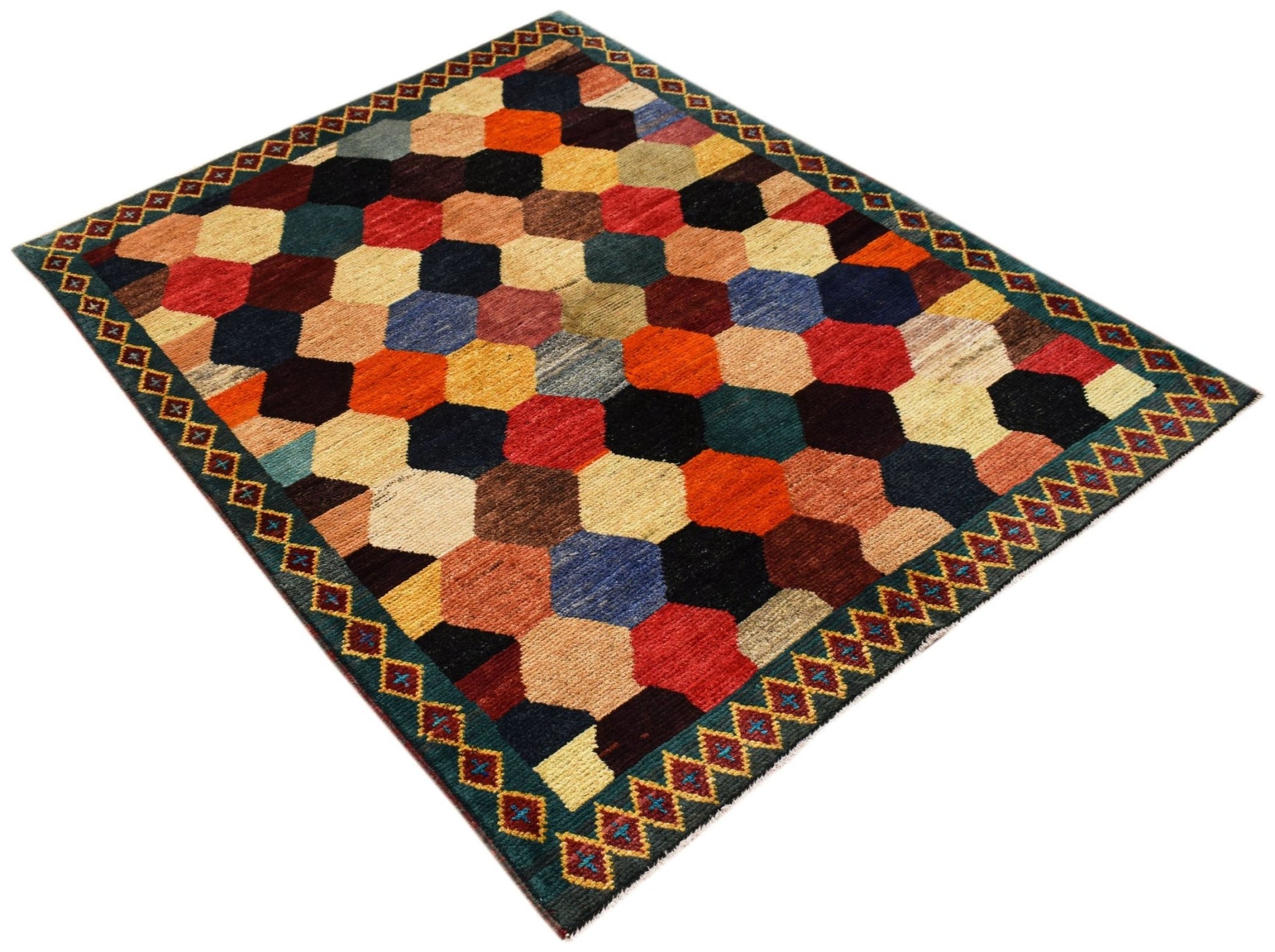 Hand-knotted Afghan wool rug featuring a colorful geometric honeycomb pattern and a bordered edge.